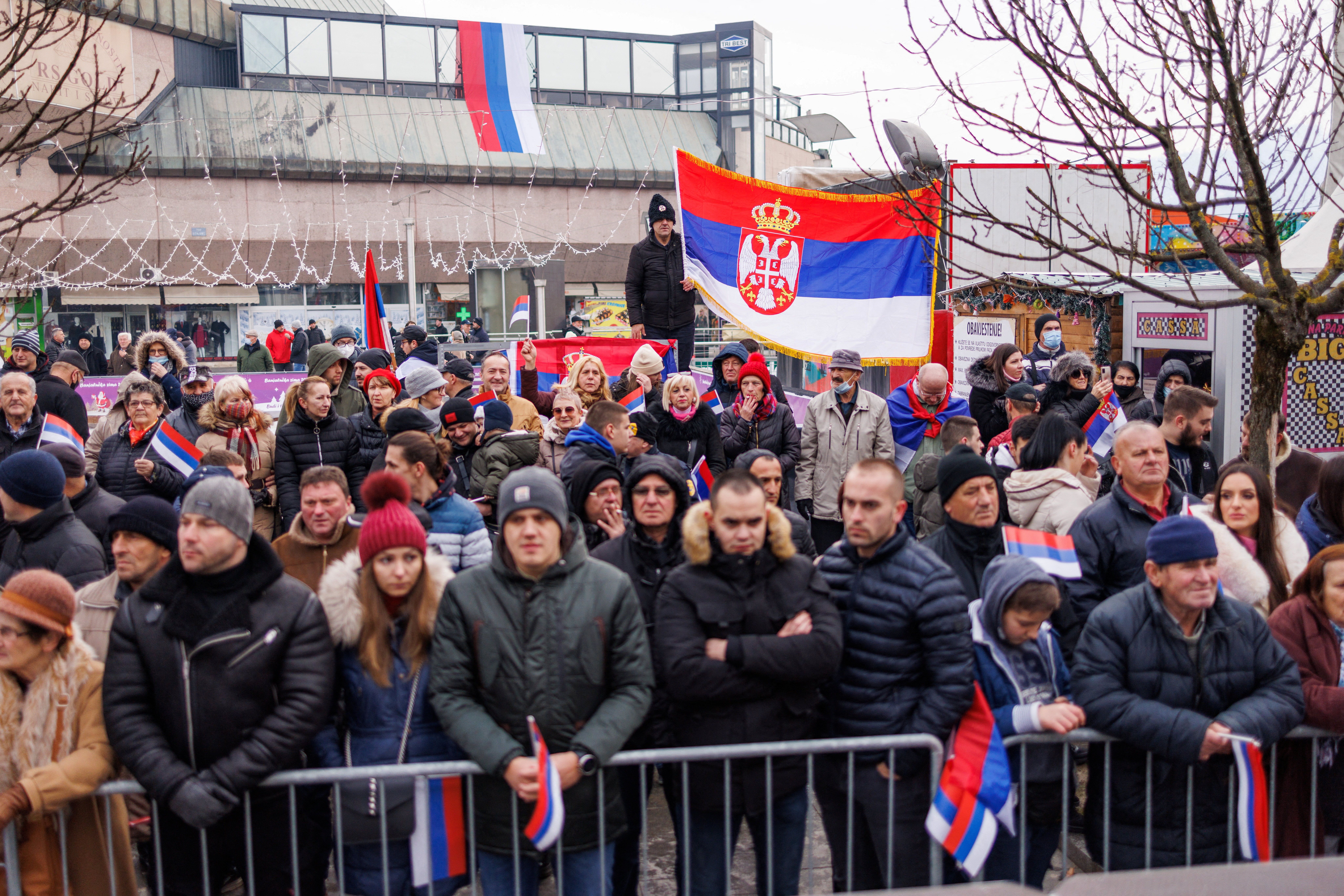 People hold Serbian and Republika Srpska flags during parade celebrations to mark their autonomous Serb Republic's national holiday, in Banja Luka
