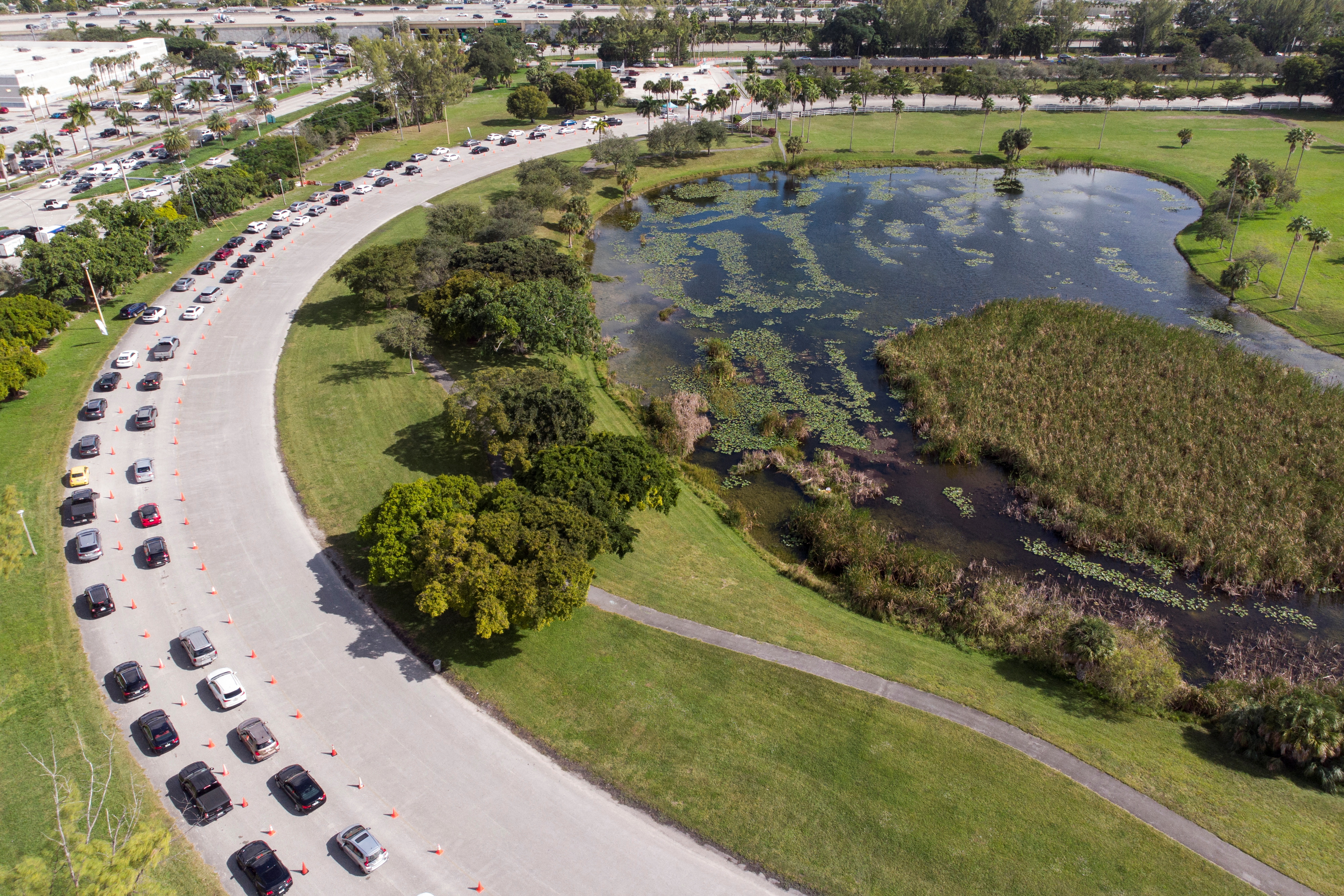 Cars wait in line at a COVID-19 drive-through testing site at Tropical Park, in Miami, Florida, U.S. December 17, 2021. Picture taken with a drone. REUTERS/Marco Bello