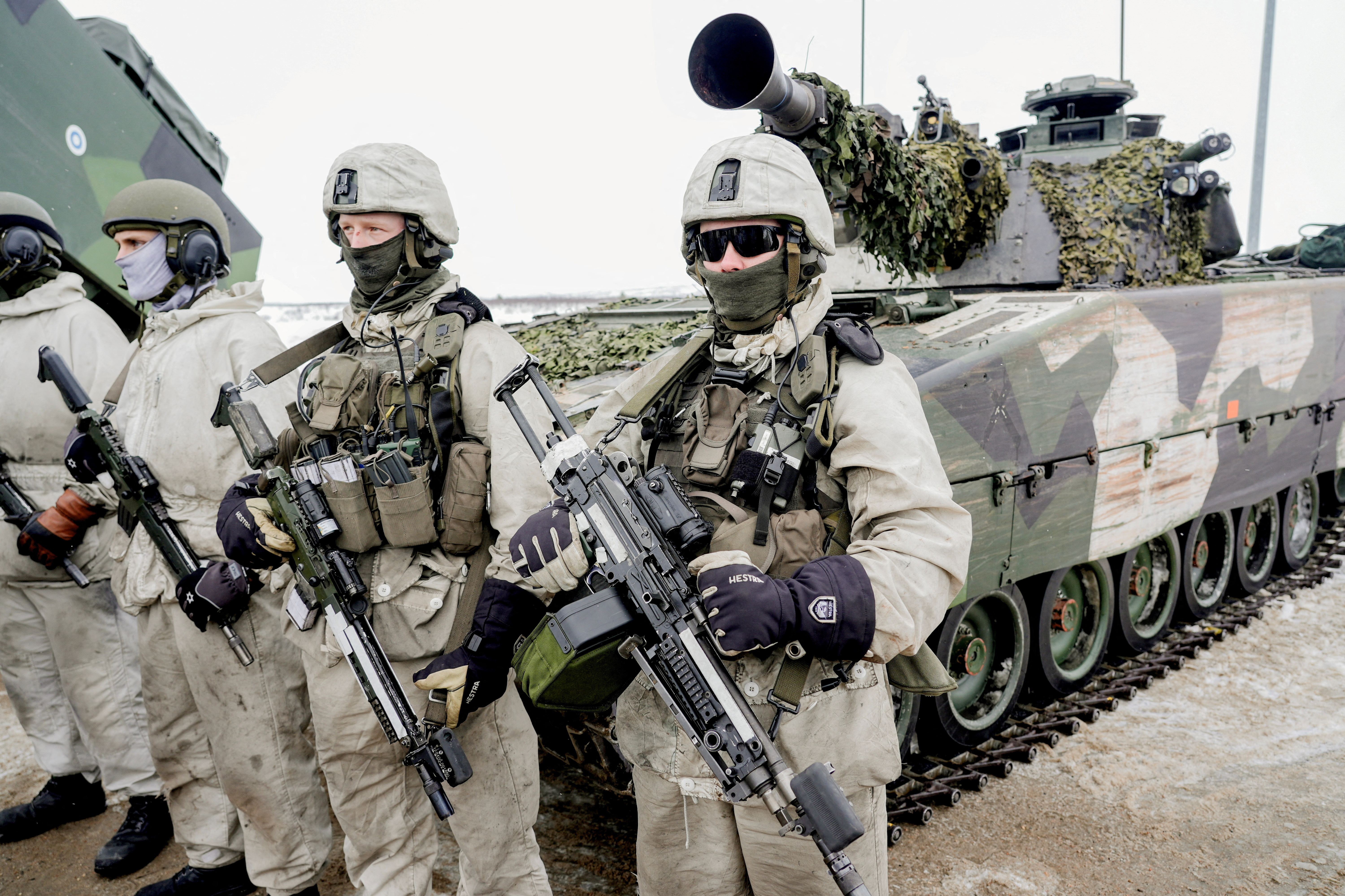 Soldiers stand next to a military vehicle as Norwegian, Swedish and Finnish forces participate in a military exercise, in Kautokeino