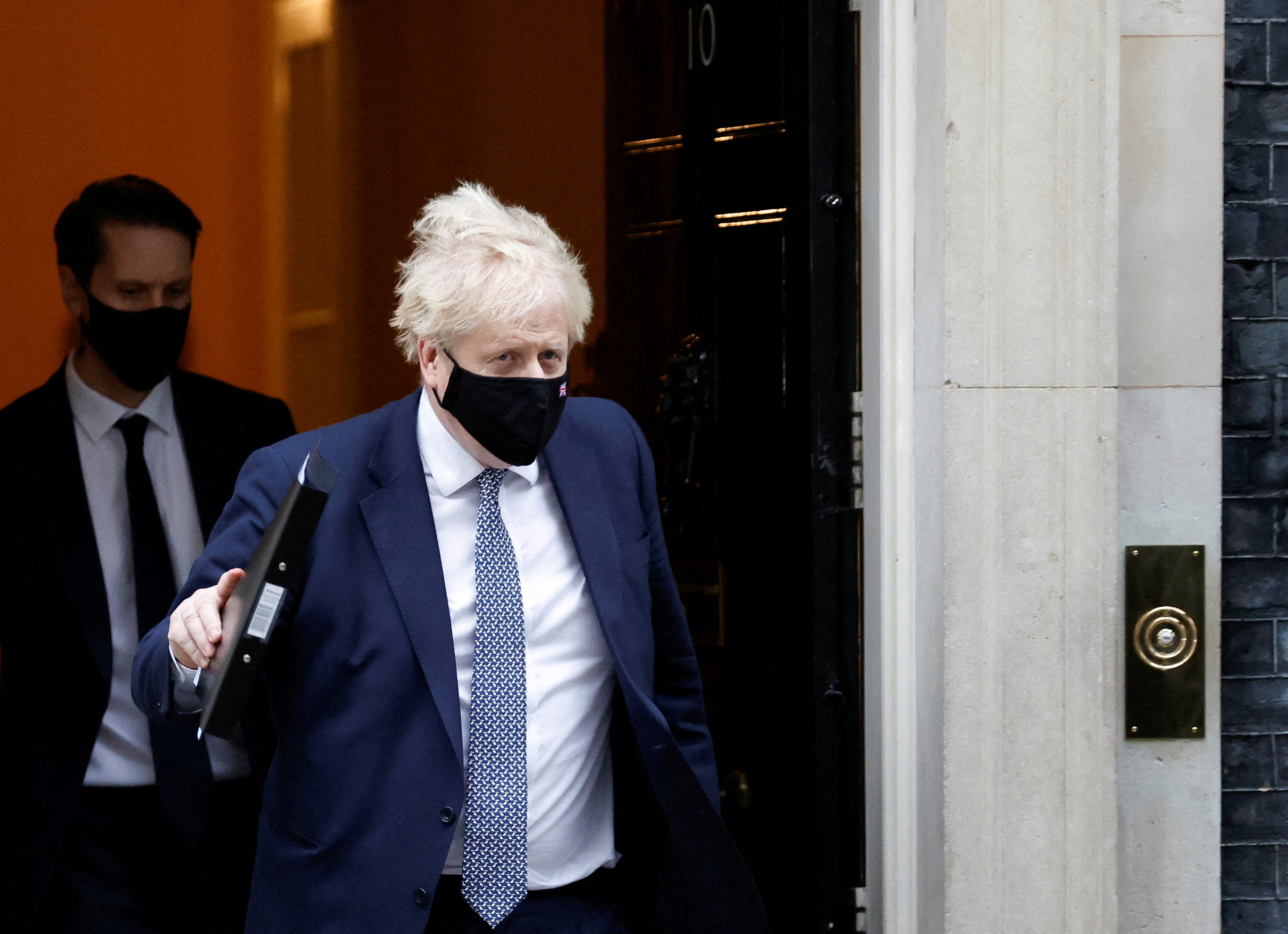 British Prime Minister Boris Johnson walks outside Downing Street in London,