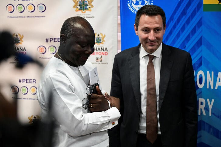 Ghana's Finance Minister Ken Ofori-Atta stands next to Stephane Roudet, IMF Mission Chief for Ghana in Accra