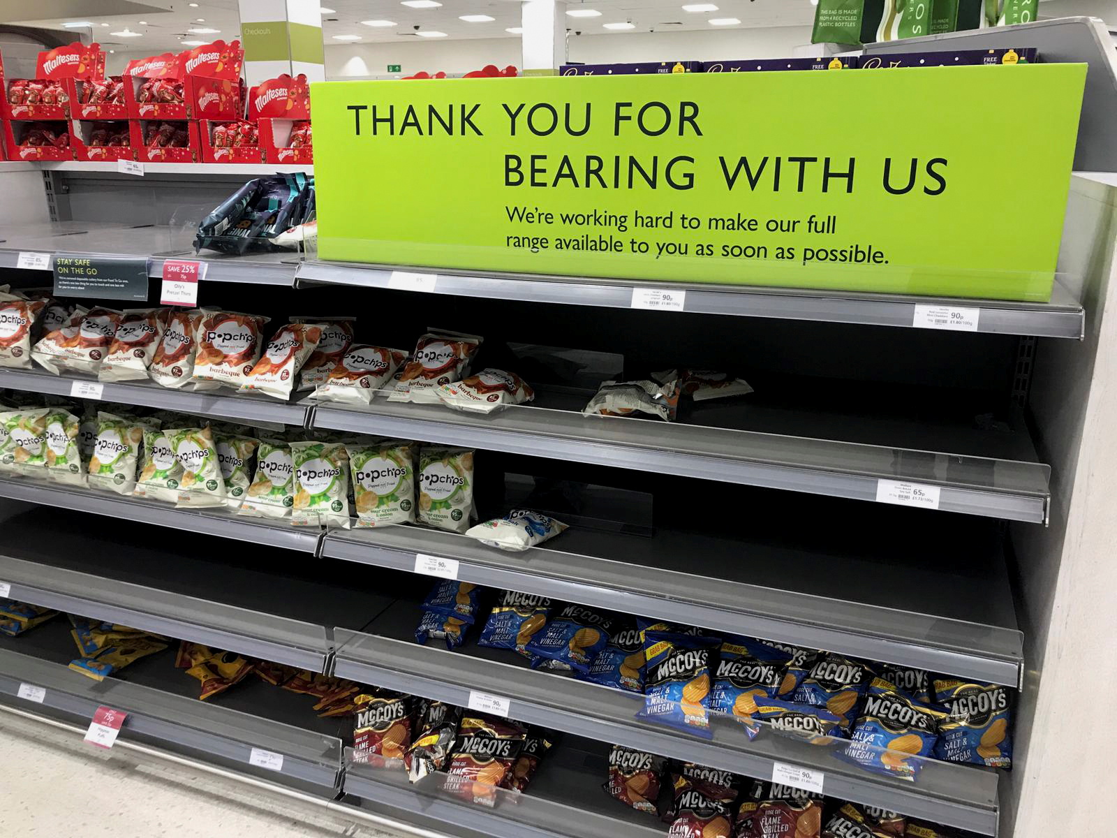 Empty crisp shelves are pictured at Waitrose supermarket, in Canary Wharf