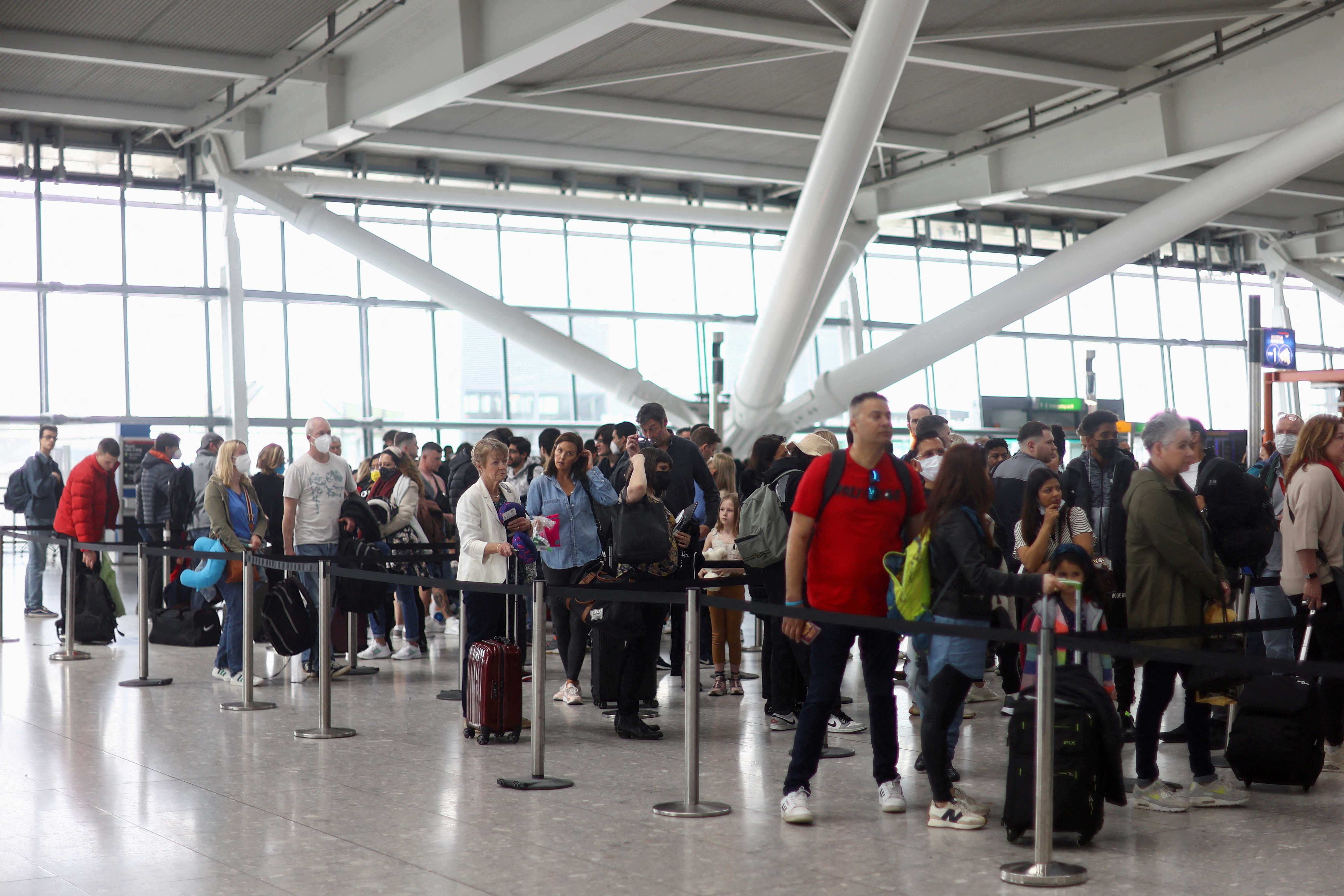 FILE PHOTO: People prepare to travel for Easter Bank Holiday weekend, at Heathrow Airport in London