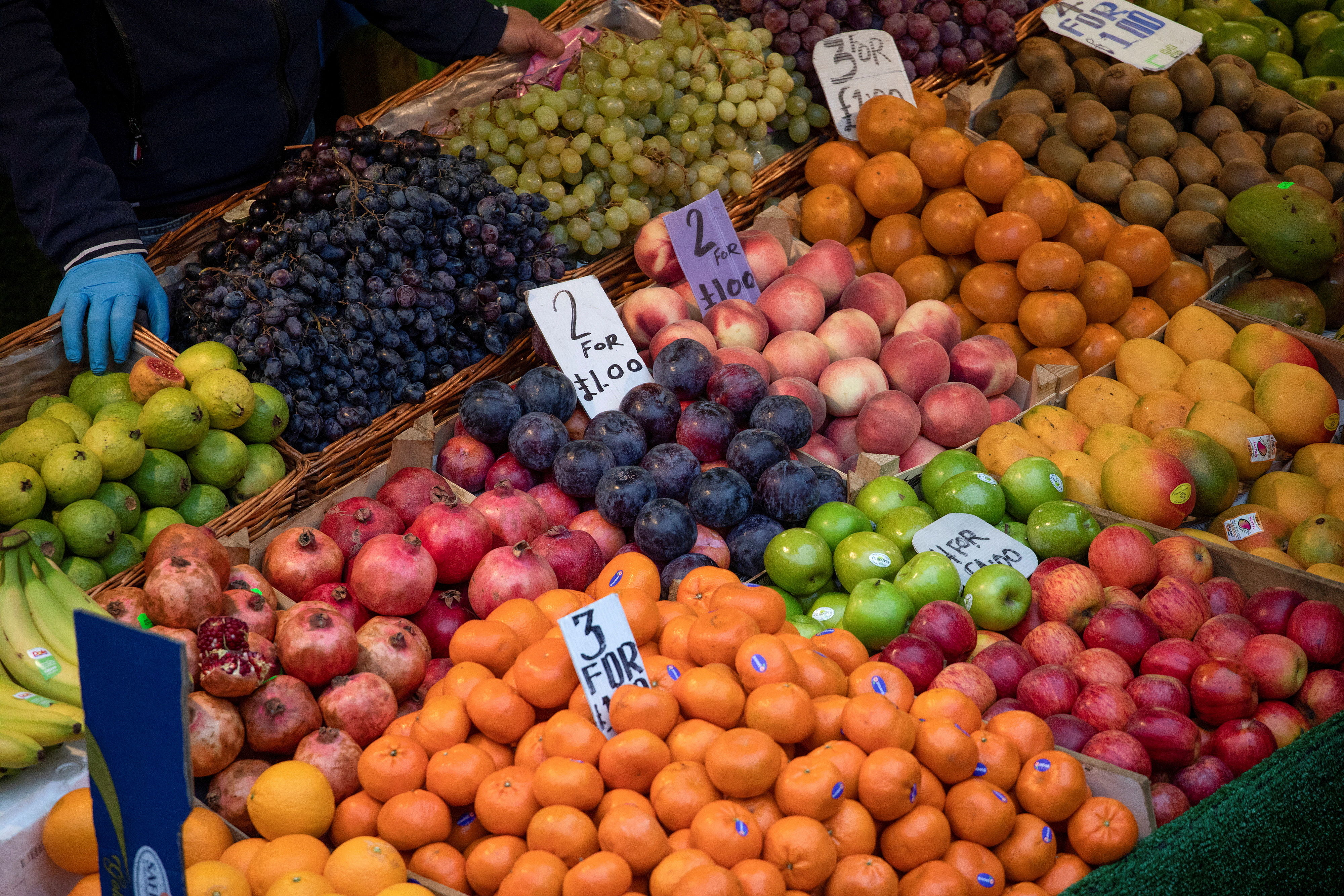 Fruit and vegetables sit on display at a fruit and vegetable  shop at Brixton Market, London, Britain