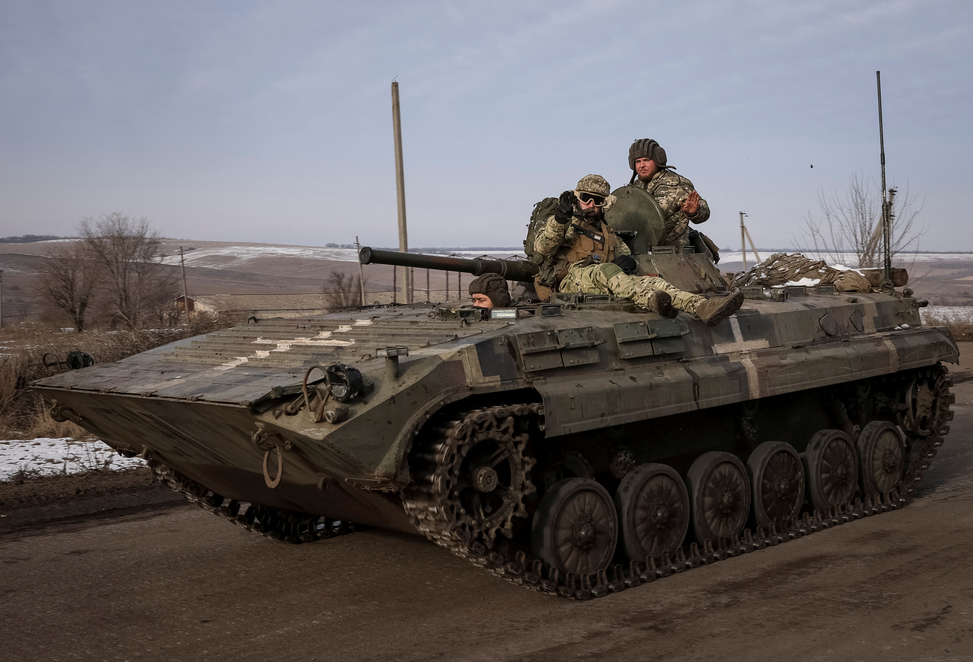 Ukrainian service members ride a BMP-1 infantry fighting vehicle near the frontline town of Bakhmut
