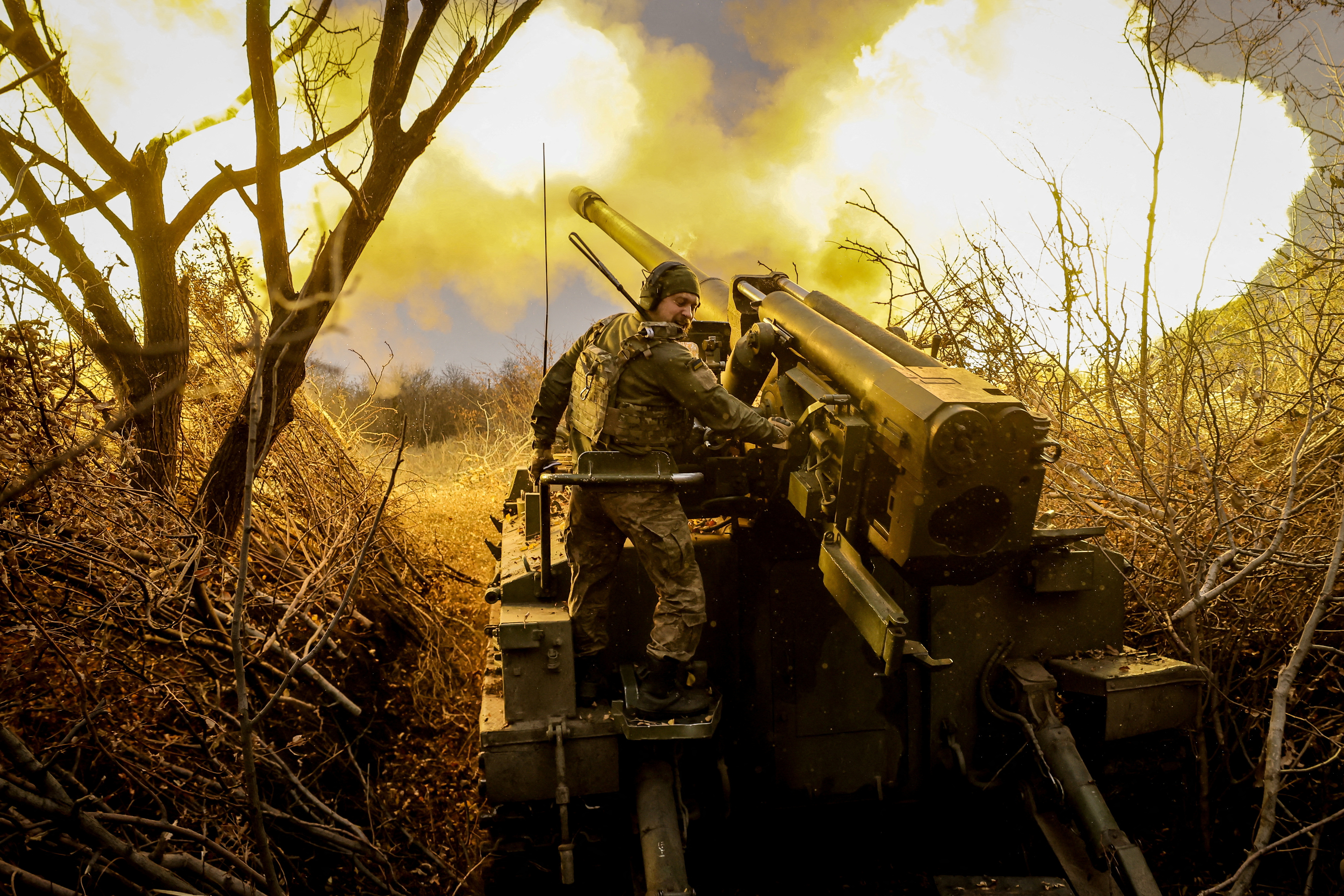 Ukrainian servicemen fire a self-propelled howitzer towards Russian troops near the frontline town of Chasiv Yar