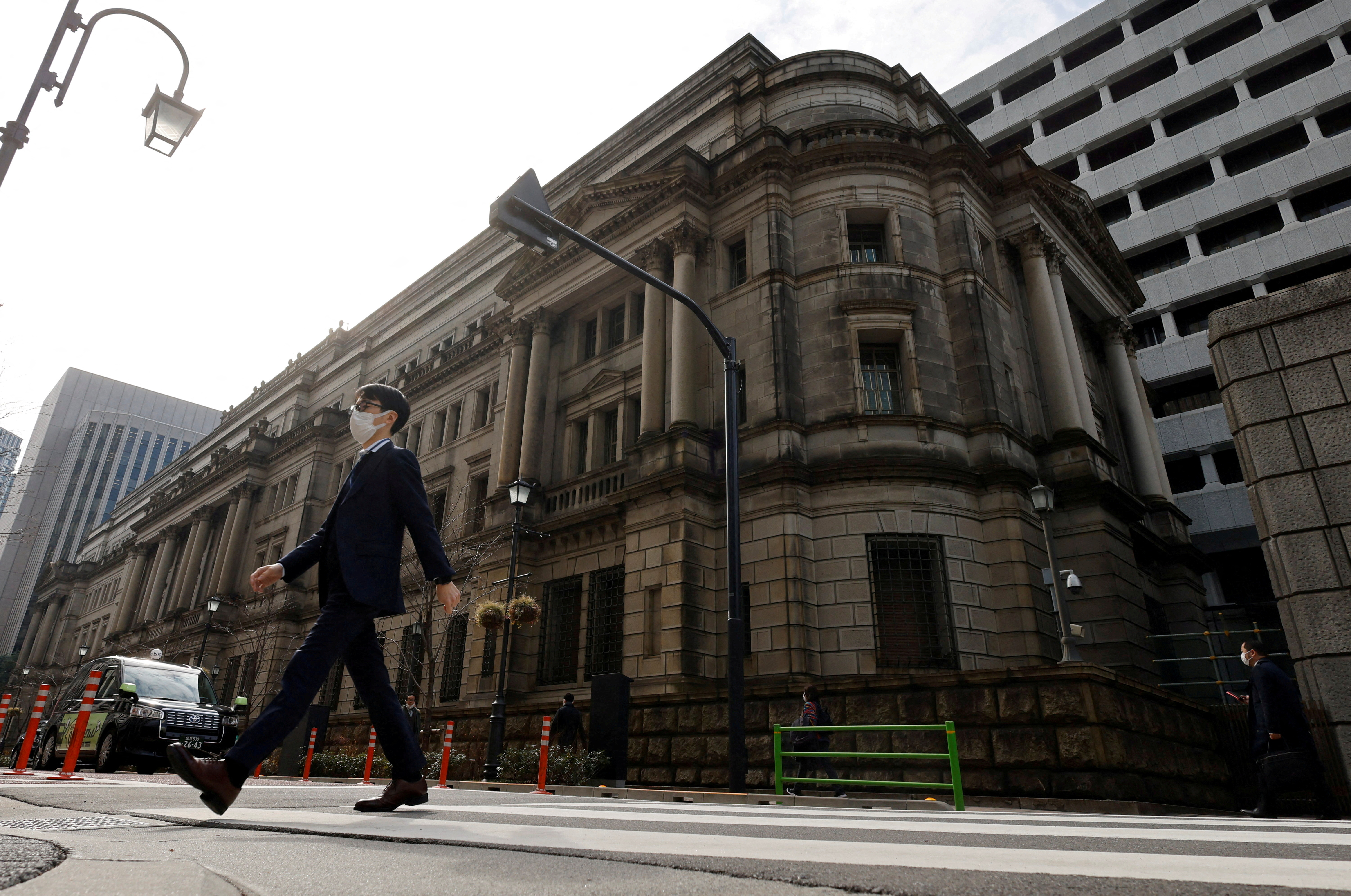 A man walks in front of the headquarters of Bank of Japan in Tokyo