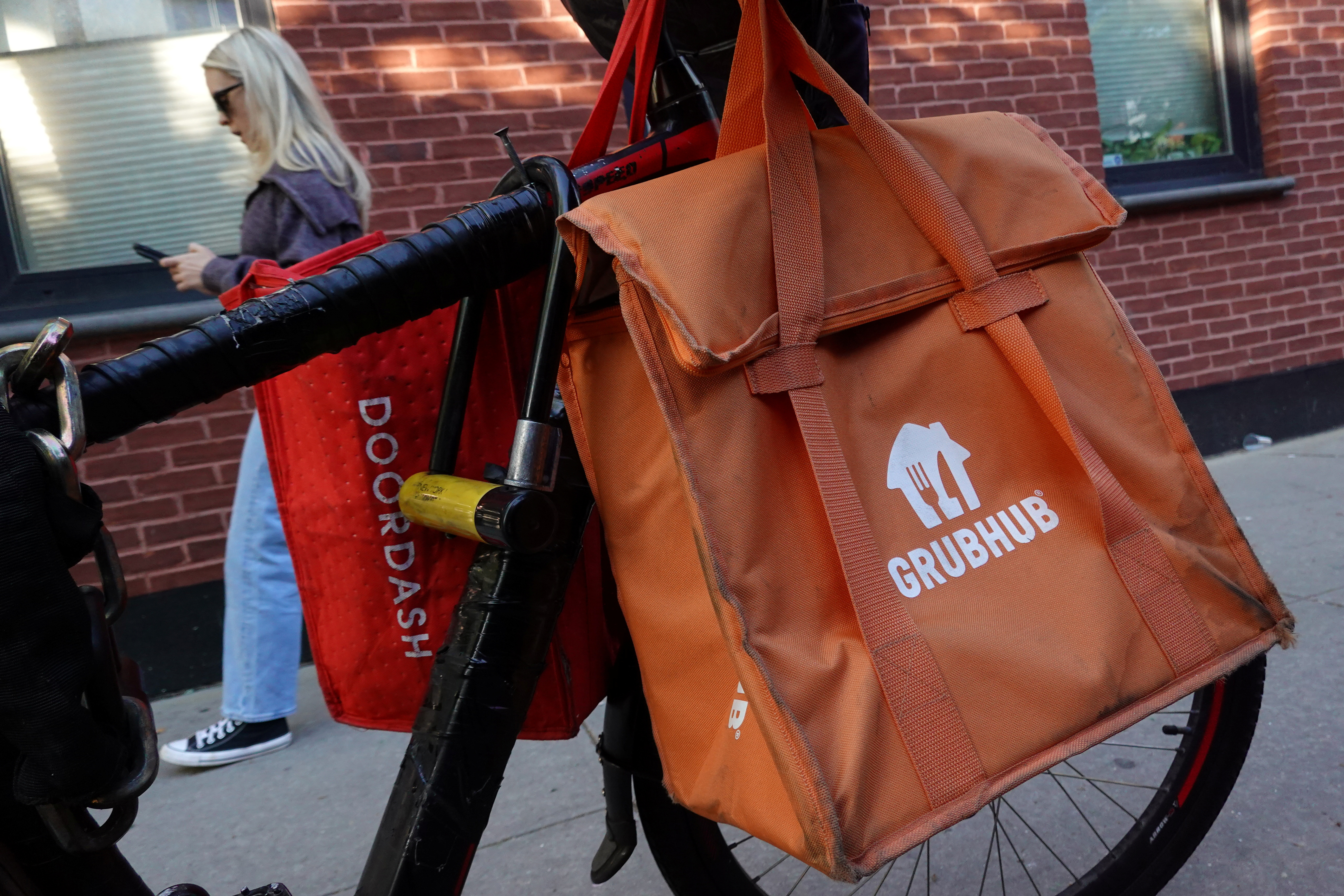 Doordash and Grubhub delivery bags are seen on a bicycle in Brooklyn, New York City
