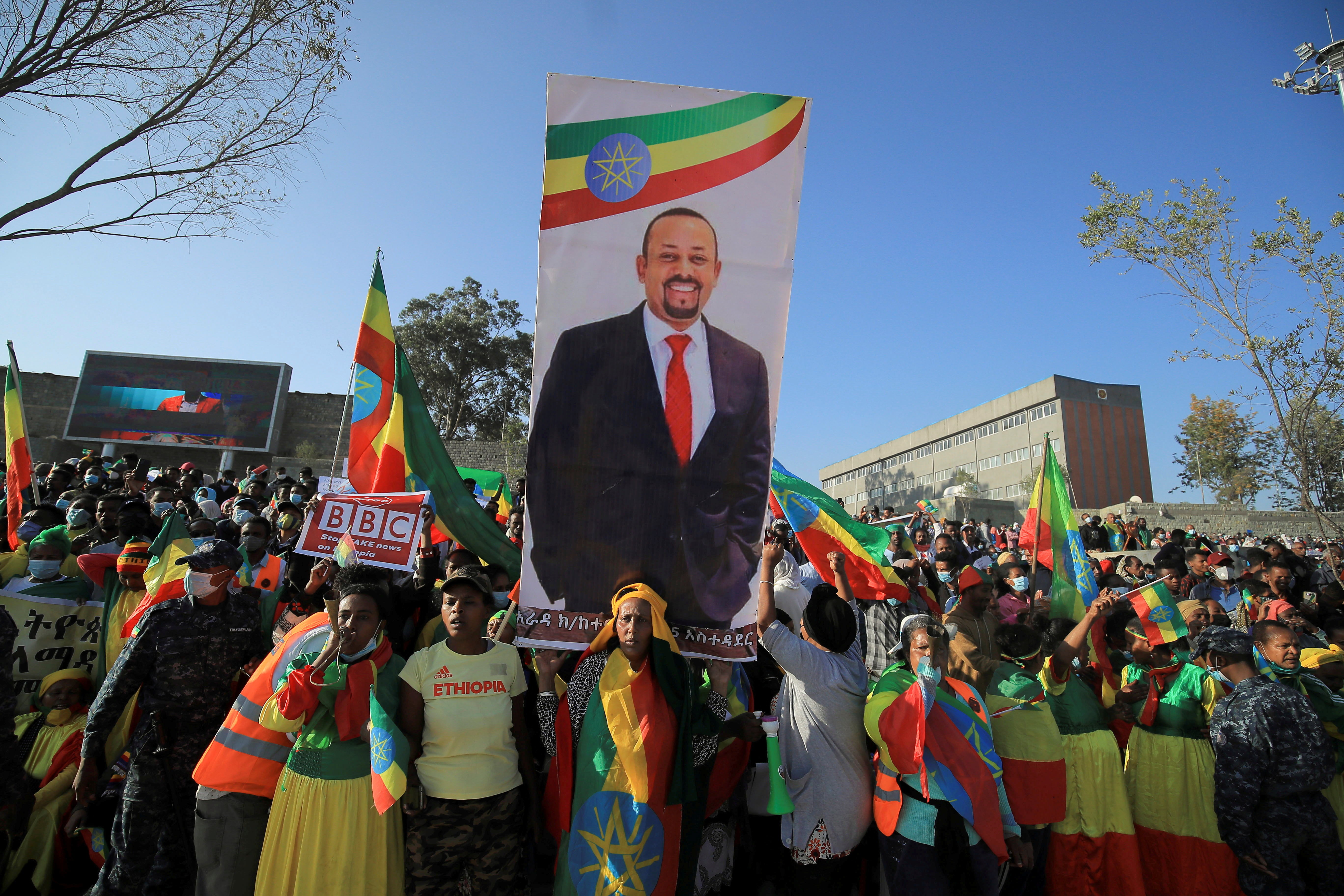 Civilians carry a placard with Prime Minister Abiy Ahmed’s portrait during a pro-government rally to denounce what the organisers say is the Tigray People’s Liberation Front (TPLF) and the Western countries' interference in internal affairs of the country, at Meskel Square in Addis Ababa, Ethiopia, November 7, 2021. REUTERS/Tiksa Negeri