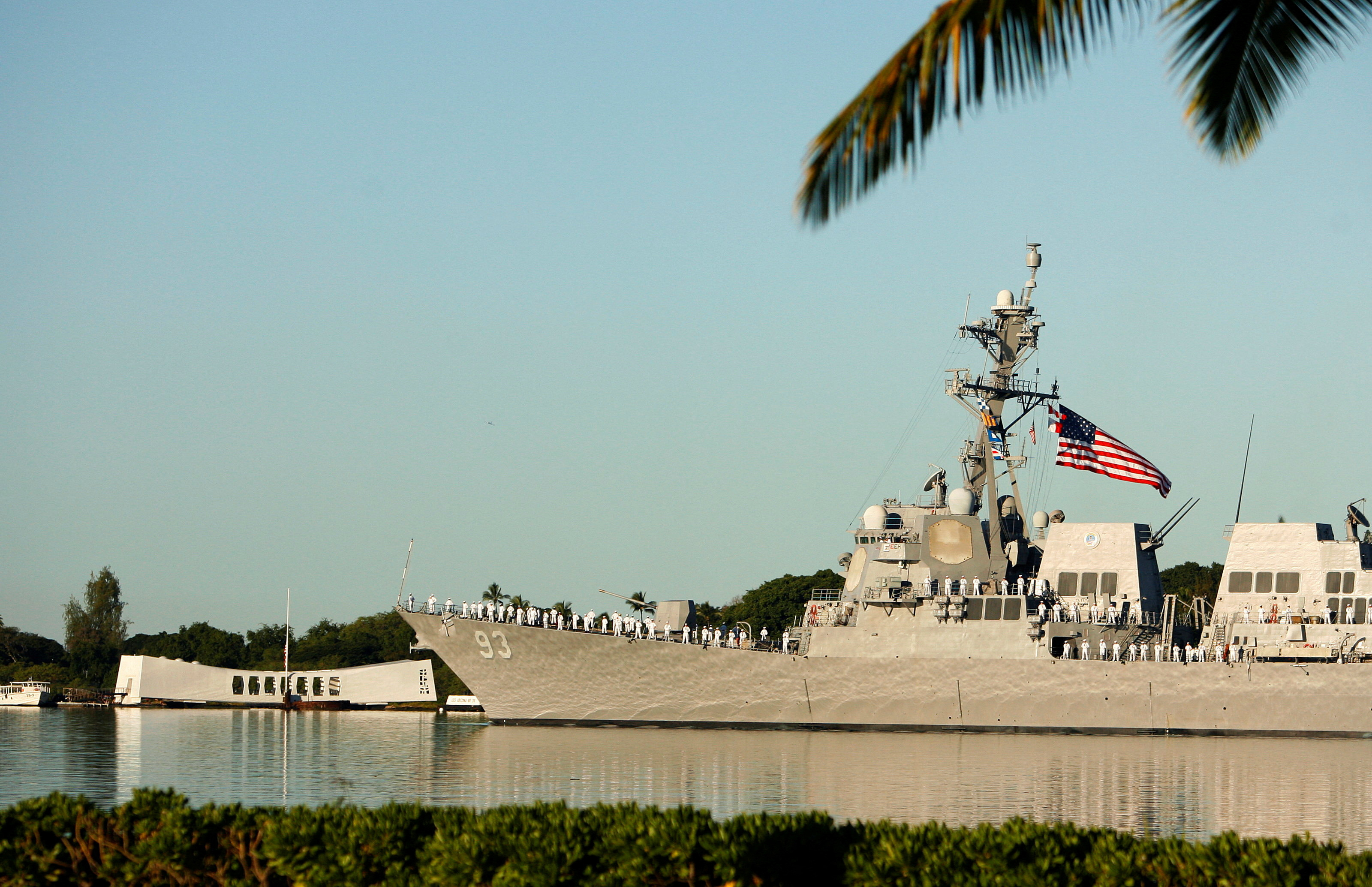 The USS Chung-Hoon passes the USS Arizona Memorial during ceremonies honoring the 73rd anniversary of the attack on Pearl Harbor at the World War II Valor in the Pacific National Monument in Honolulu, Hawaii.