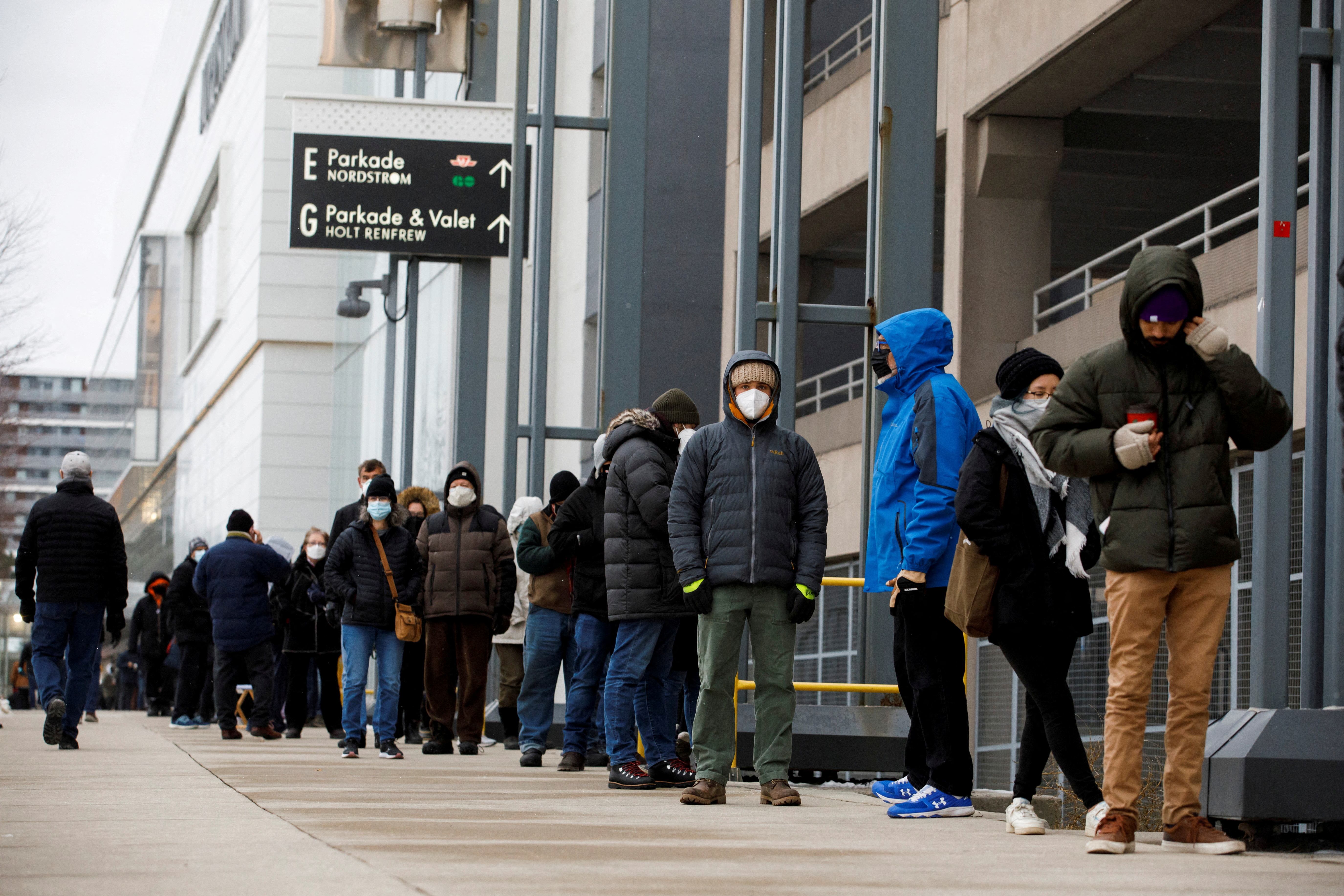 People queue to pick up COVID-19 antigen test kits in Toronto