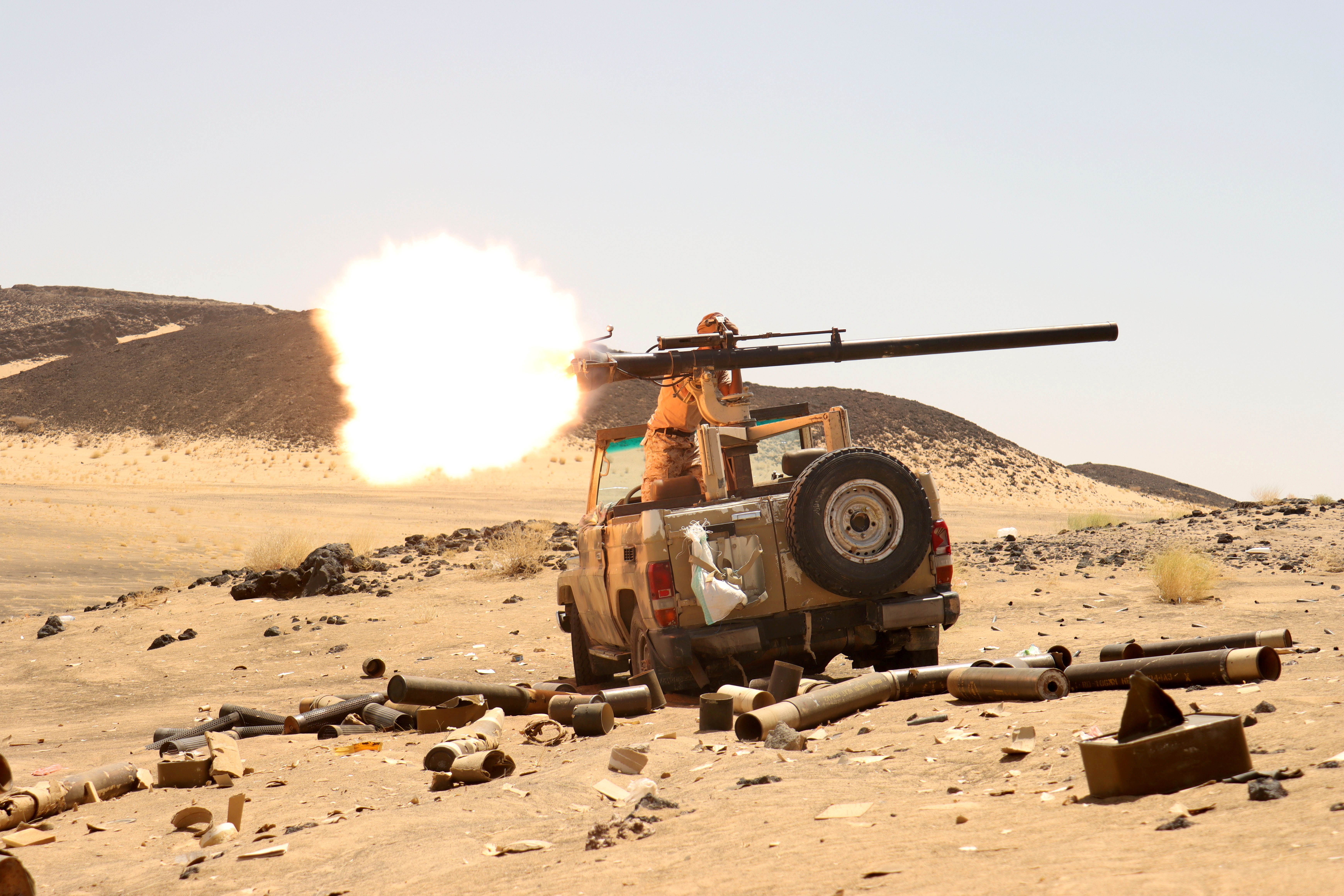 Yemeni government fighter fires a vehicle-mounted weapon at a frontline position during fighting against Houthi fighters in Marib