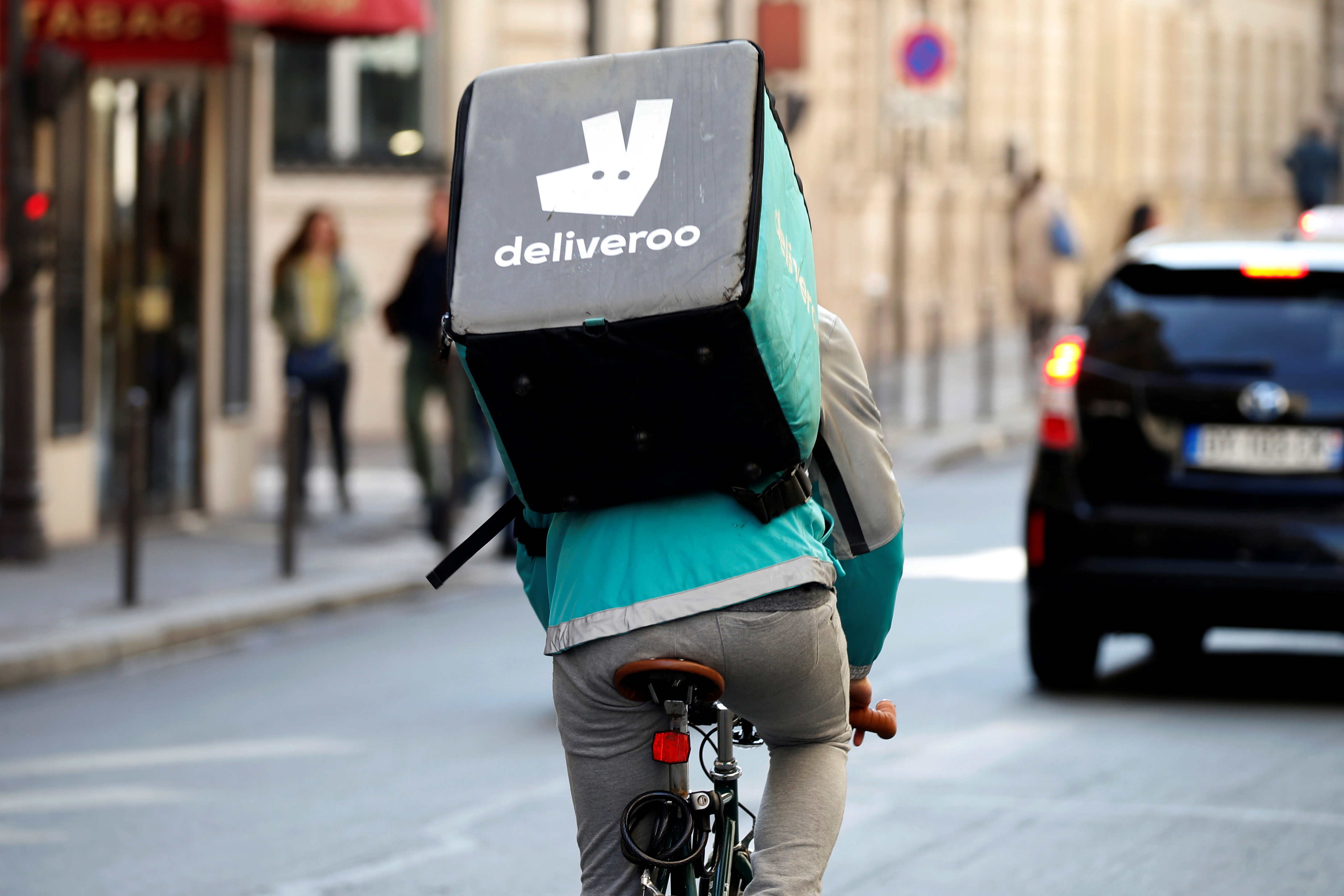 A cyclist rides a bicyle as he delivers food for Deliveroo, an example of the emergence of what is known as the 'gig economy', in Paris