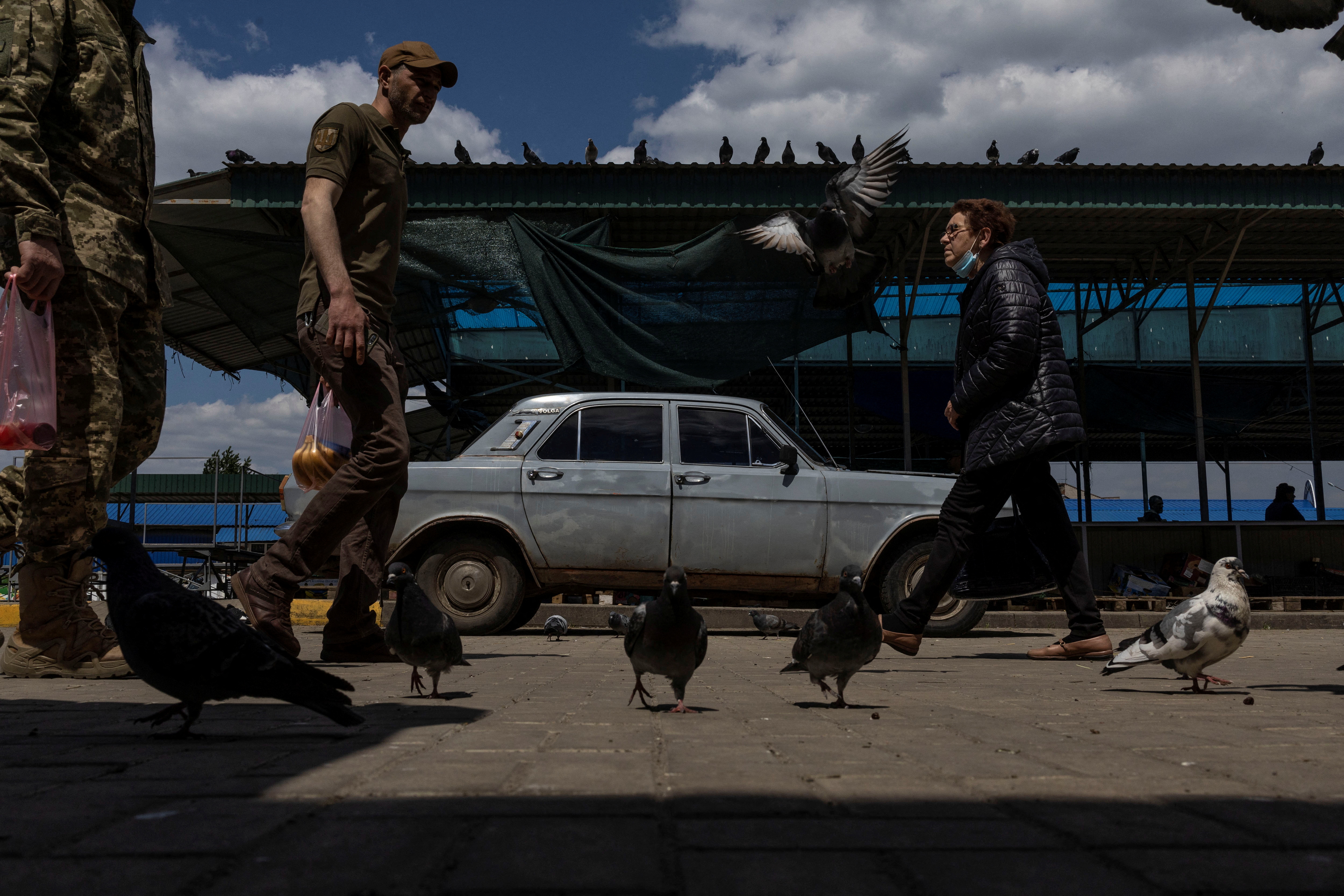 A Ukrainian serviceman walks along a local market, amid Russia's invasion of Ukraine in the city of Slovyansk, Donetsk region, Ukraine