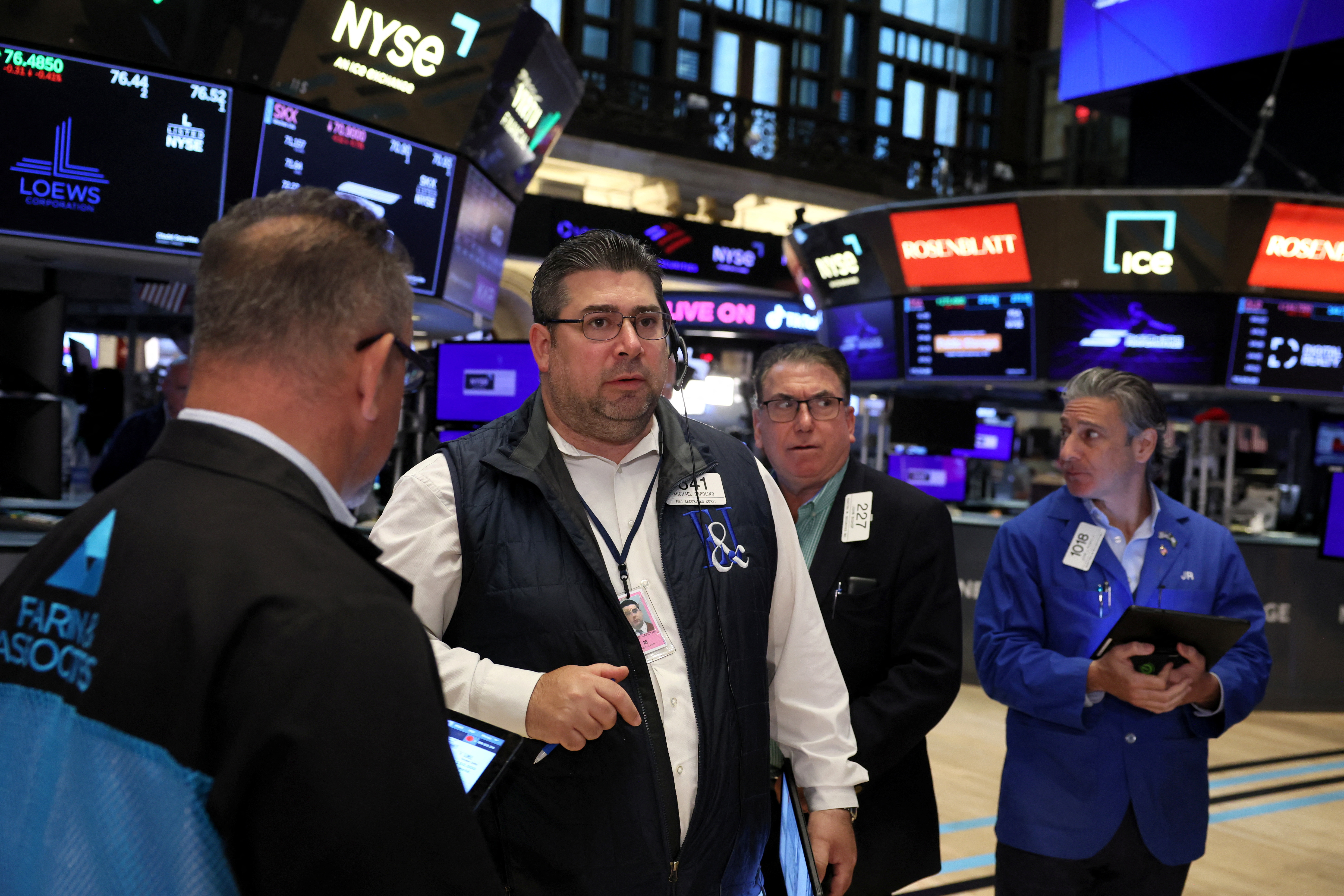Traders and floor officials react to technical issues on the floor of the NYSE in New York