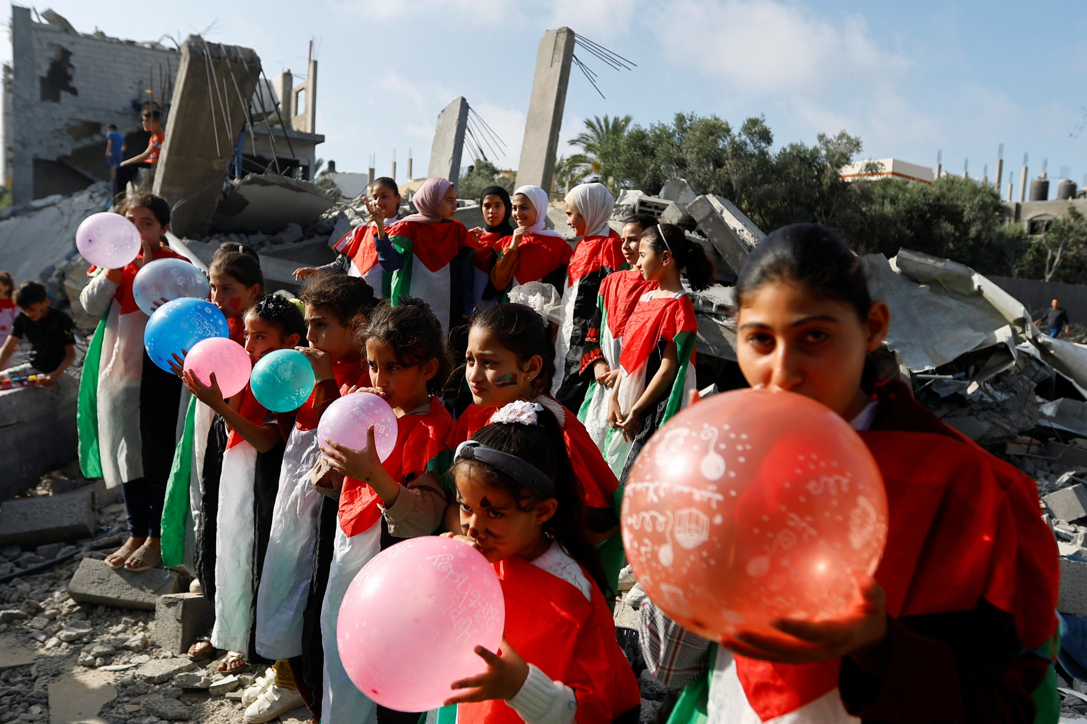 Palestinian children participate in an activity aimed to support their mental health in Deir al-Balah