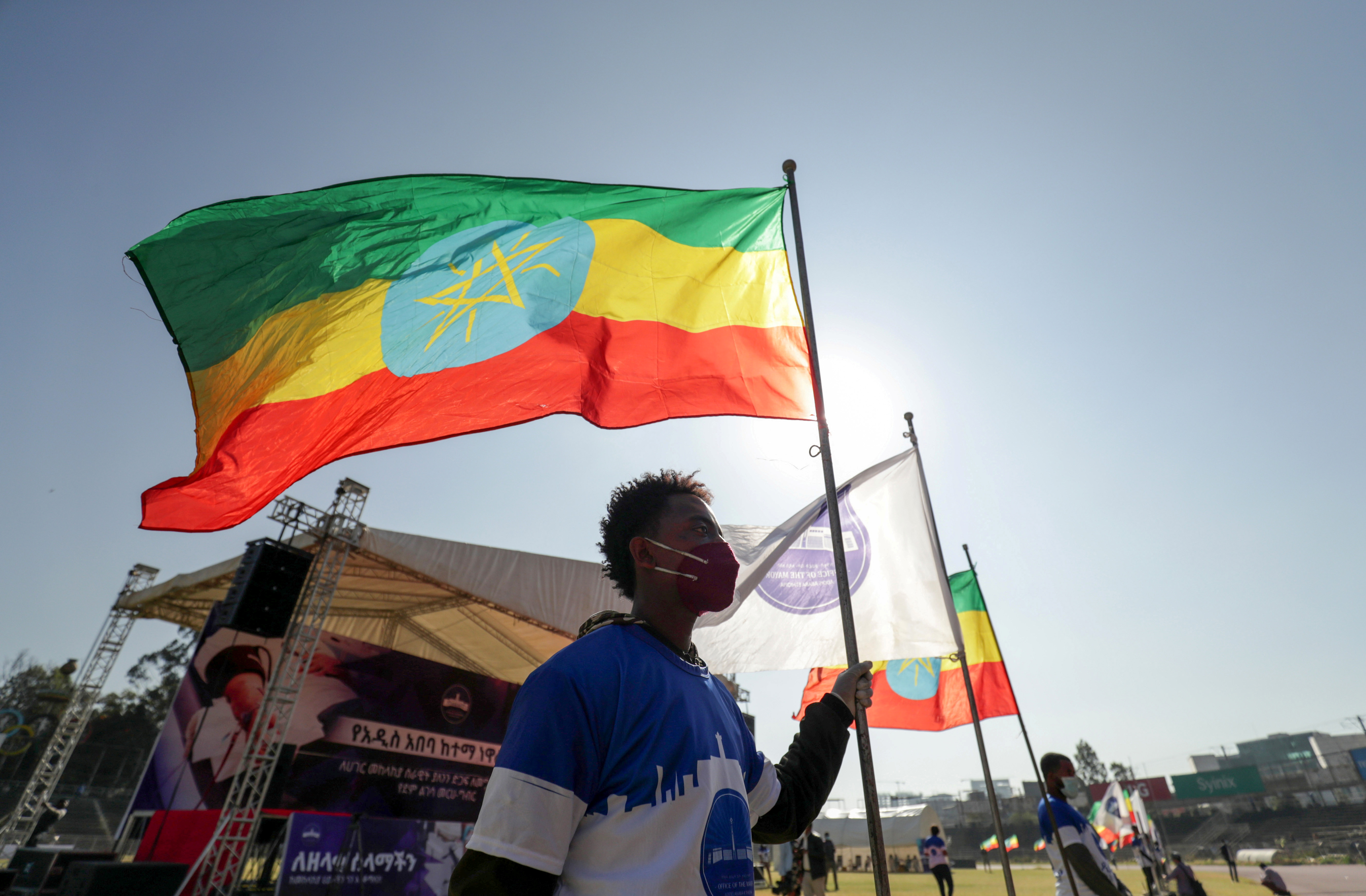 A volunteer holds an Ethiopian flag during a blood donation ceremony for the injured members of Ethiopia's National Defense Forces, at the stadium in Addis Ababa