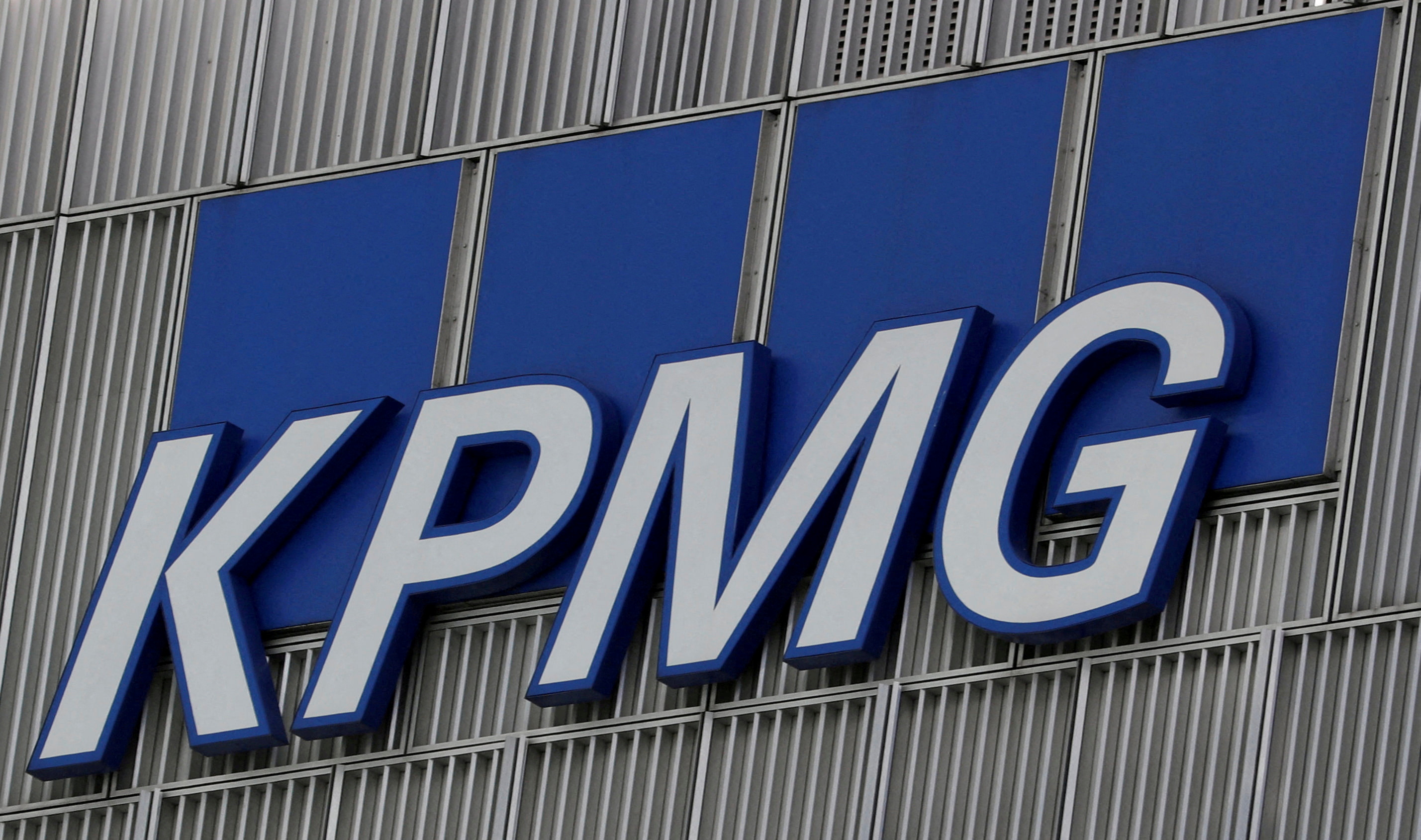 The KPMG logo is seen at their offices at Canary Wharf financial district in London