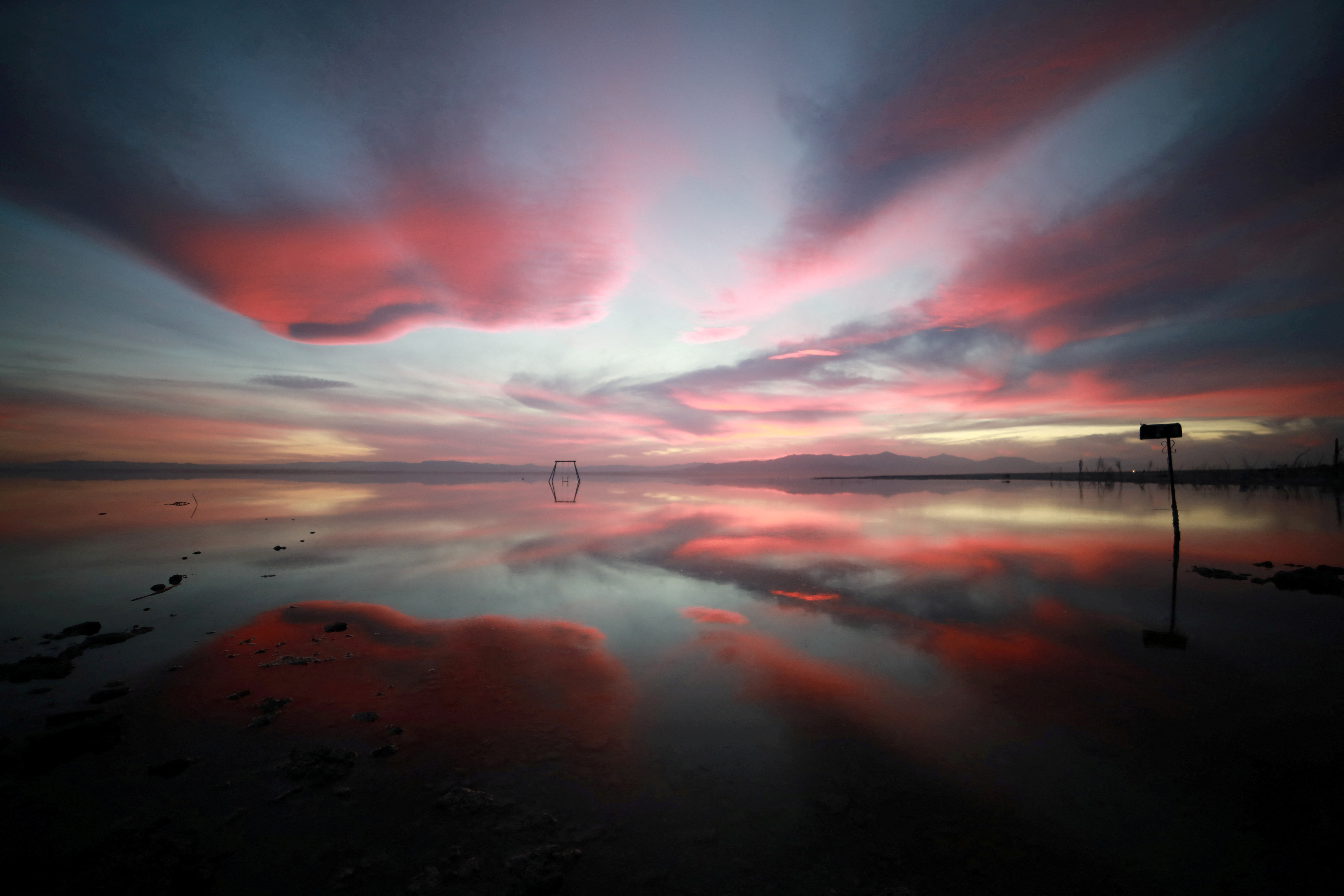 Sunset is reflected in the Salton Sea as seen from Bombay Beach