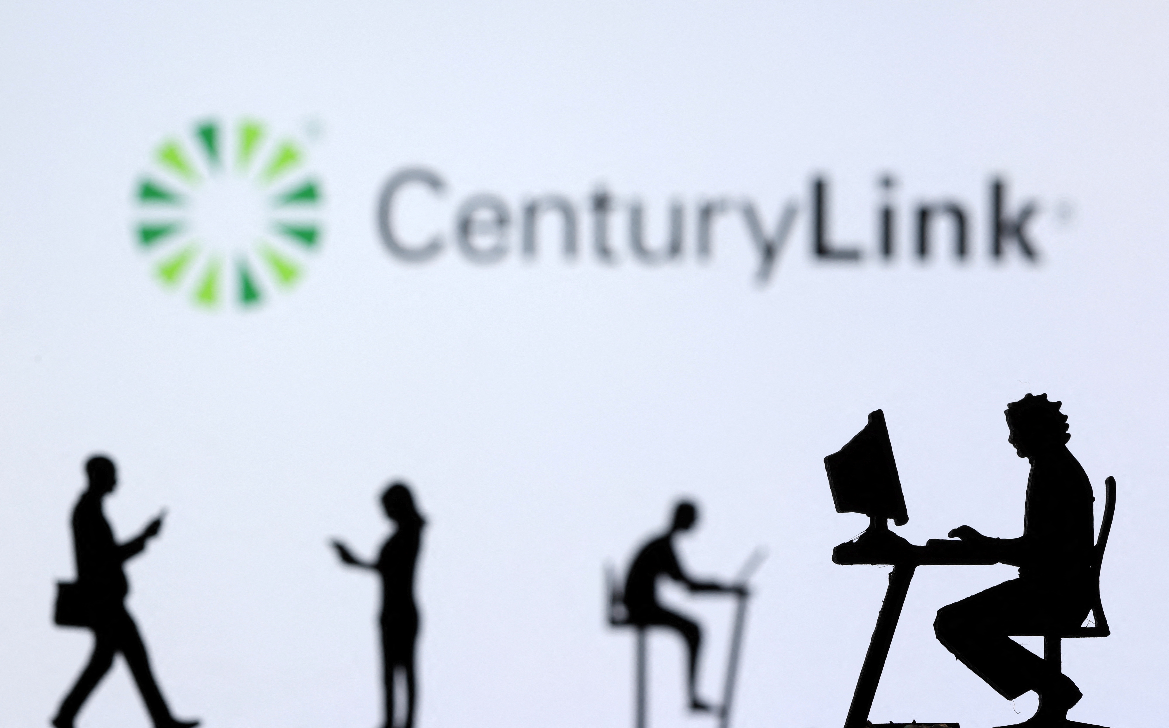 Illustration shows small toy figures with laptops and smartphones in front of displayed CenturyLink Internet logo