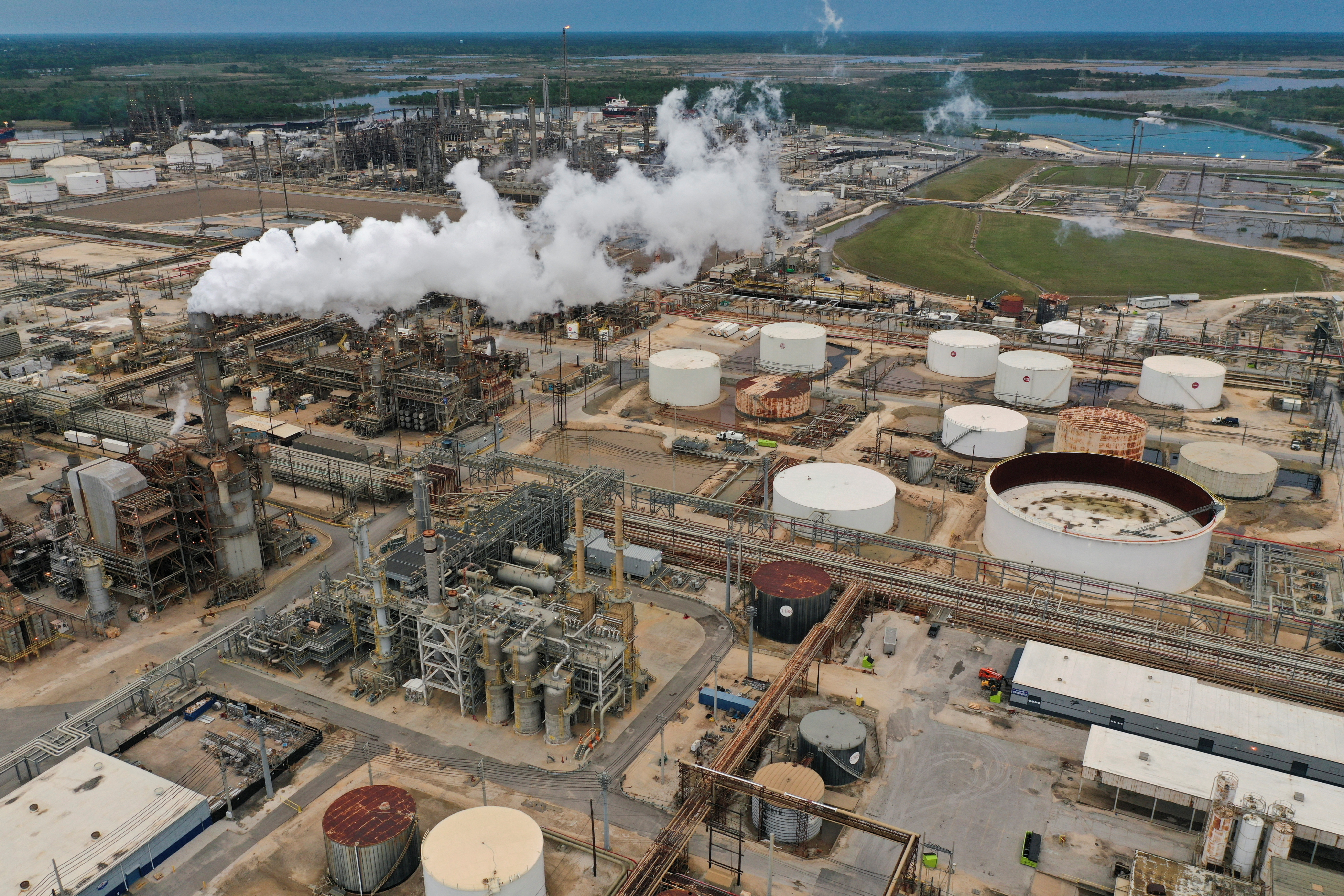 An aerial view shows flue gas and steam rising from a distillation tower at Exxon Mobil’s Beaumont oil refinery