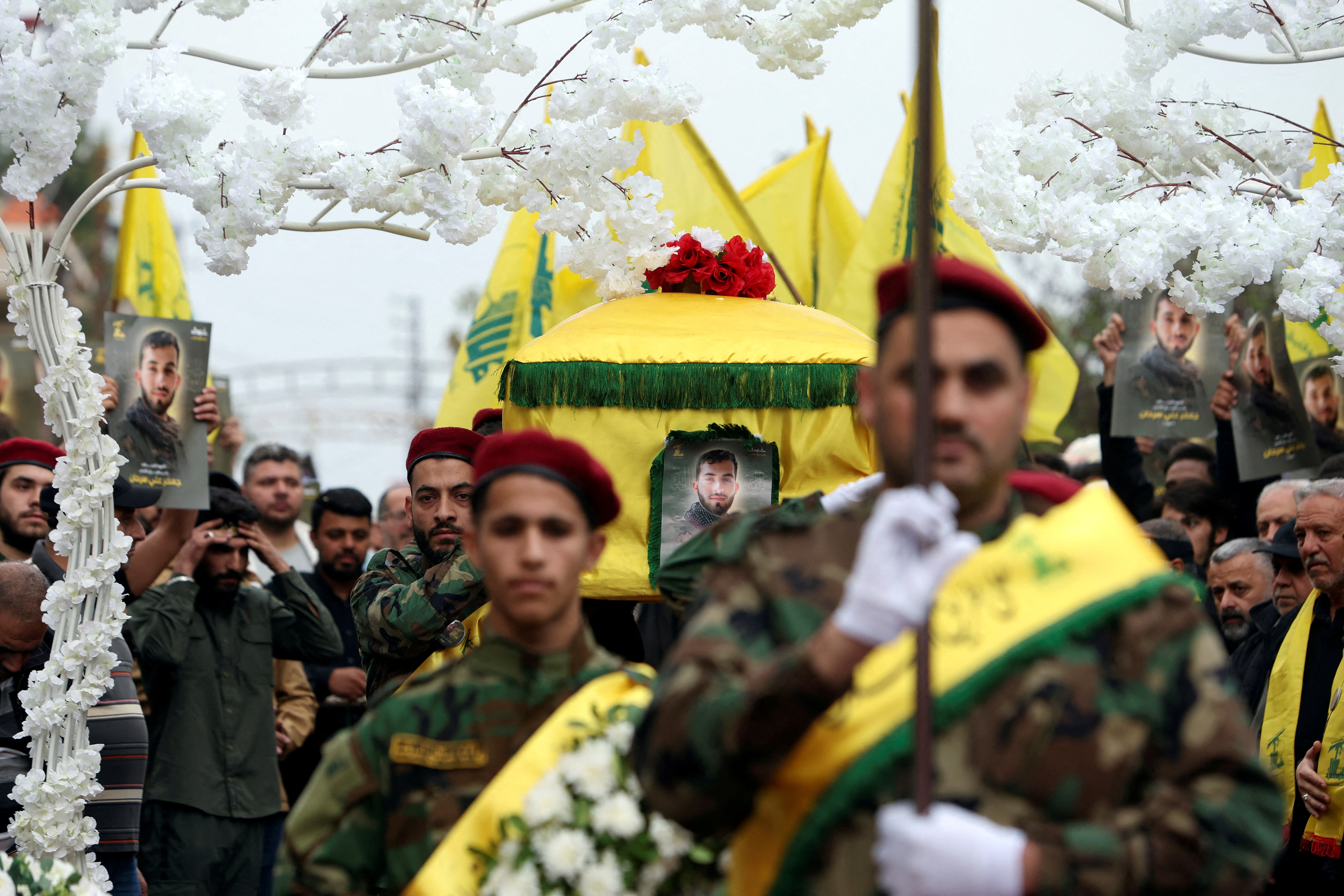 Members of Hezbollah carry the coffin of Hezbollah member Jaafar Serhan, during his funeral in Mashghara