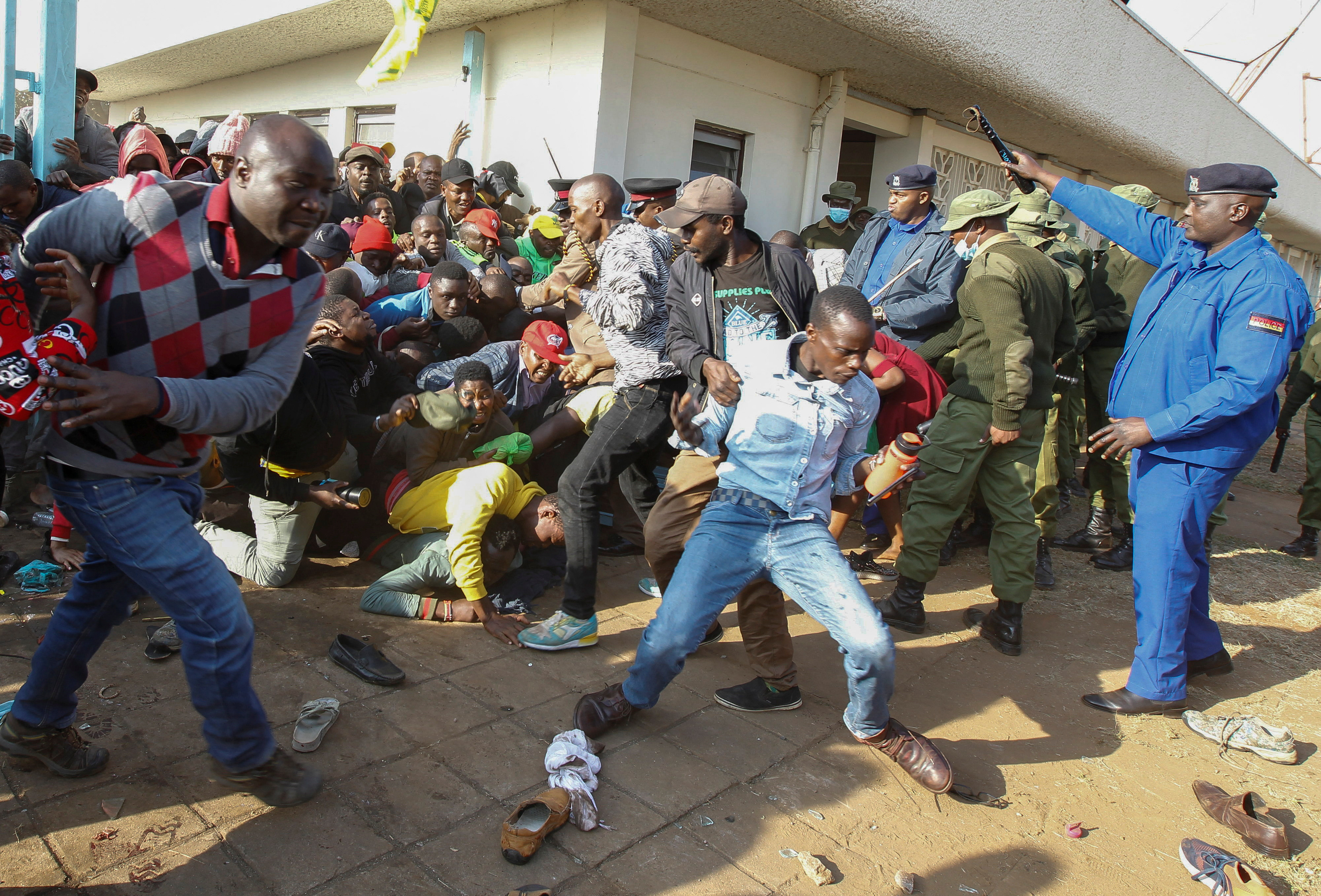 People fall in a stampede as they jostle to attend the inauguration of Kenya's President William Ruto before his swearing-in ceremony at the Moi International Stadium Kasarani in Nairobi