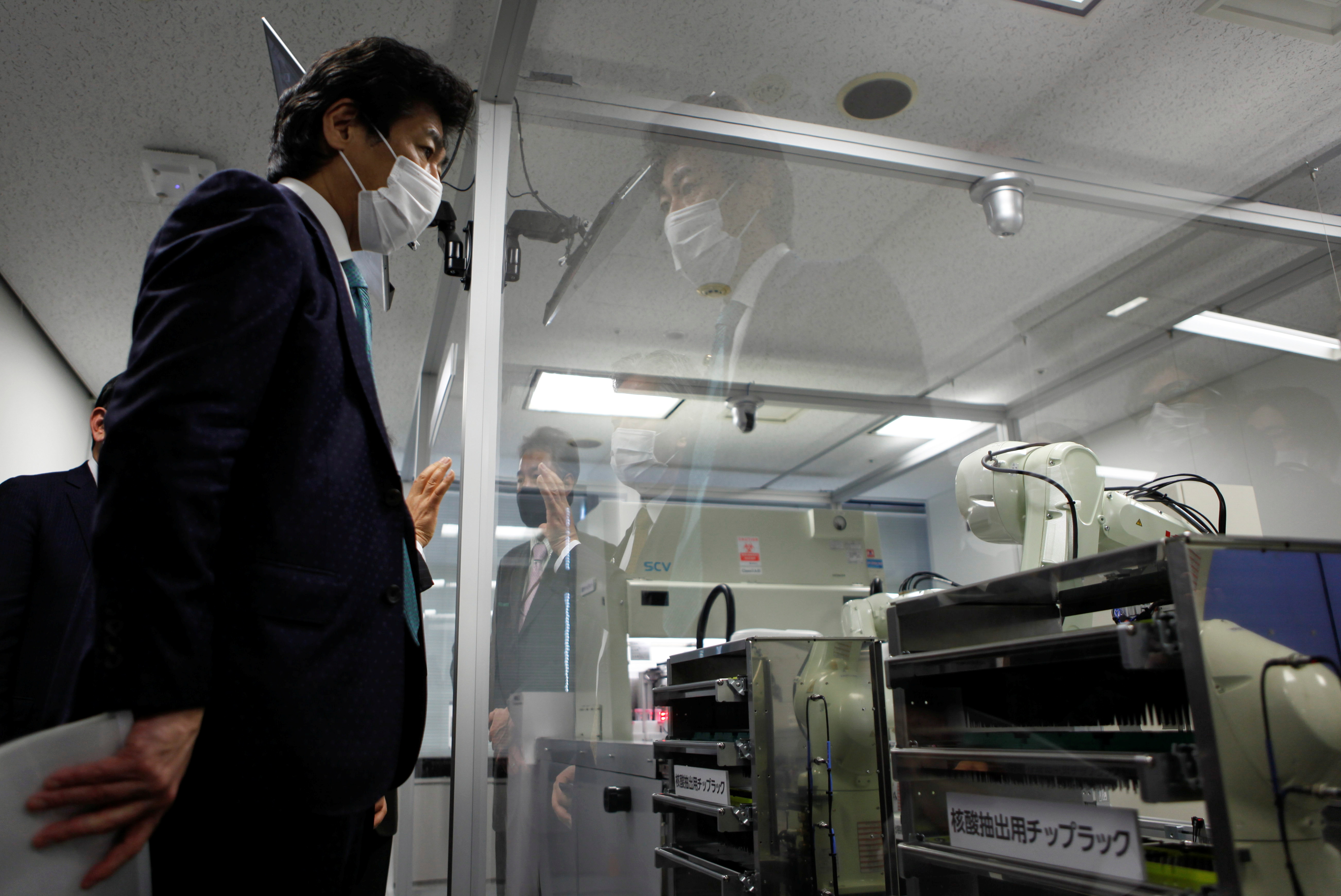 Japan's Health Minister Norihisa Tamura visits the Kawasaki Heavy Industries' Tokyo Robot Centre in Tokyo