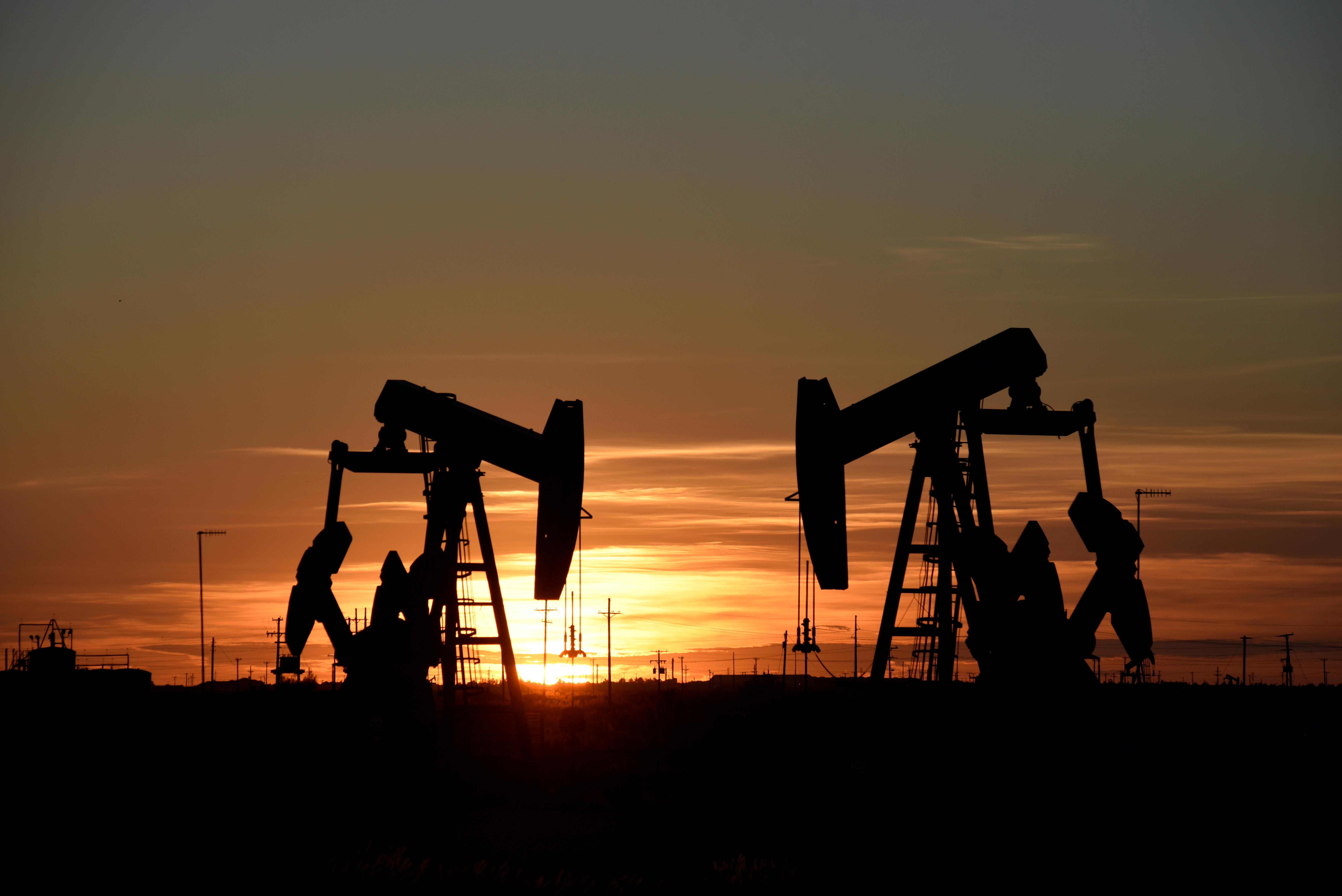 Pump jacks operate at sunset in an oil field in Midland, Texas U.S. August 22, 2018. REUTERS/Nick Oxford