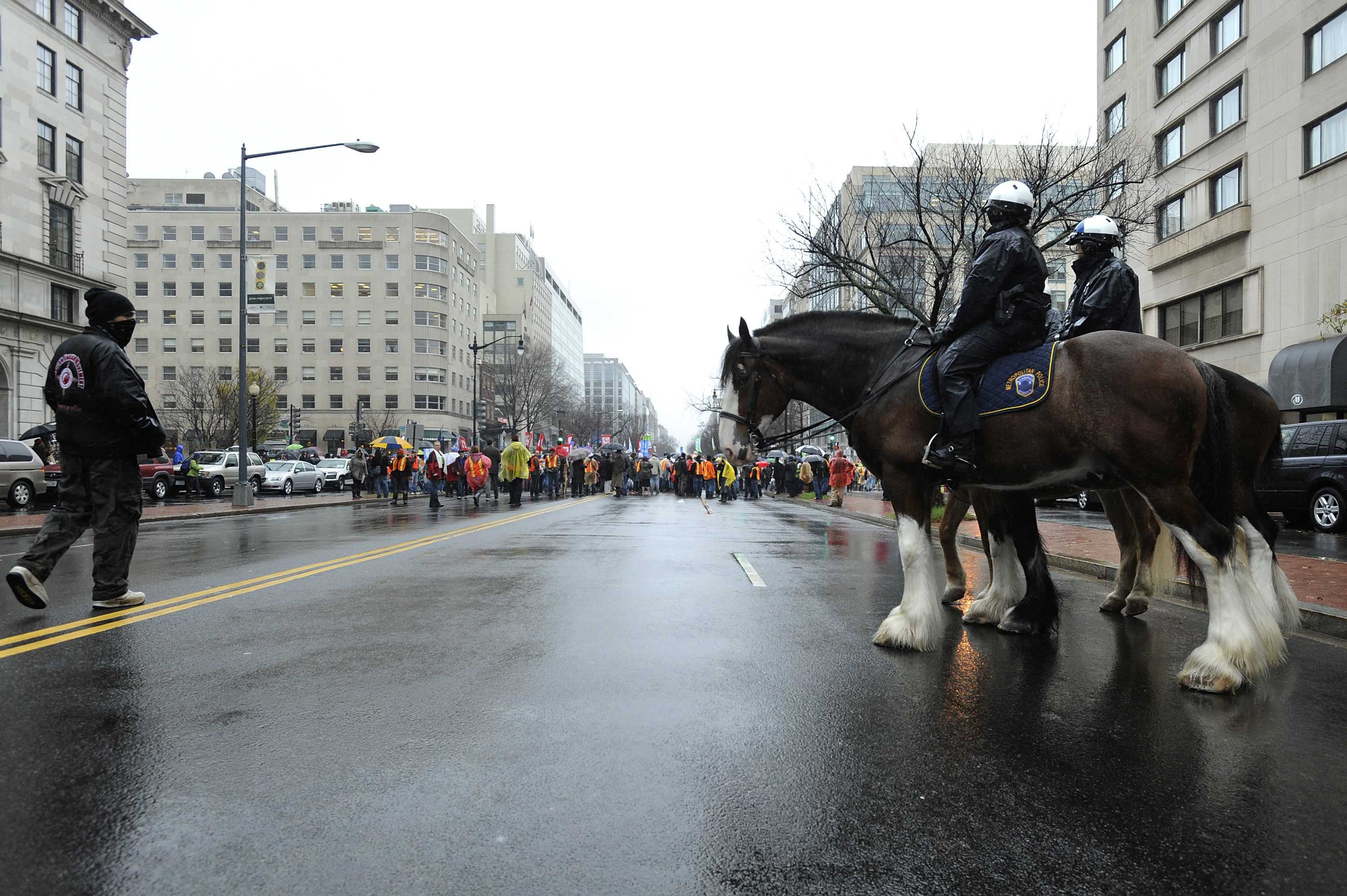 Mounted police officers stand by as protesters from the Occupy movement march through the streets of the national's capital, tying up the famed K Street lobbyist corridor in Washington