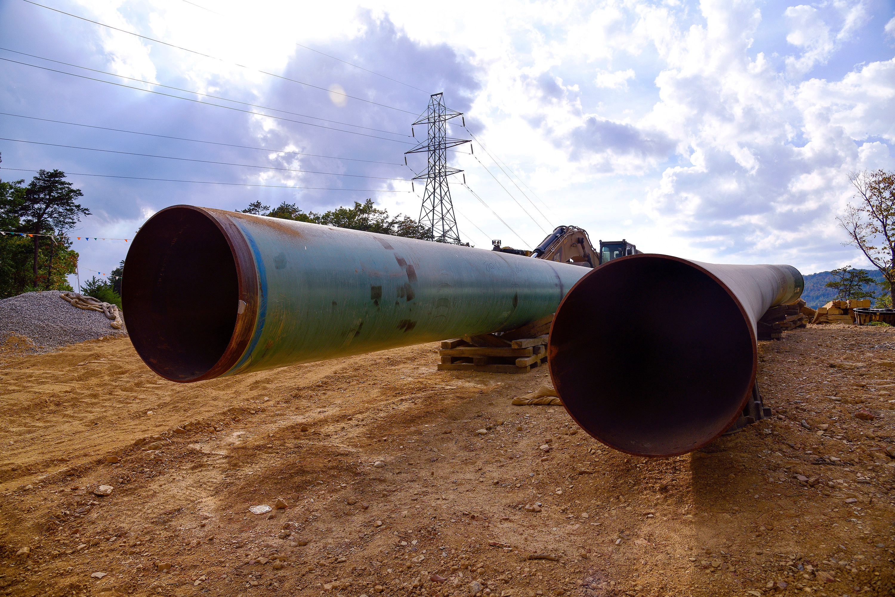 Lengths of pipe wait to be laid in the ground along the under-construction Mountain Valley Pipeline near Elliston, Virginia