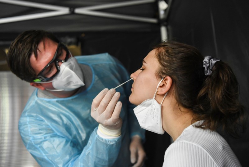 A medical worker takes a swab sample from Luisa during a coronavirus disease (COVID-19) test, on the premises of the brewing company BrewDog beside their DogTap restaurant in Berlin, Germany May 11, 2021.  REUTERS/Annegret Hilse