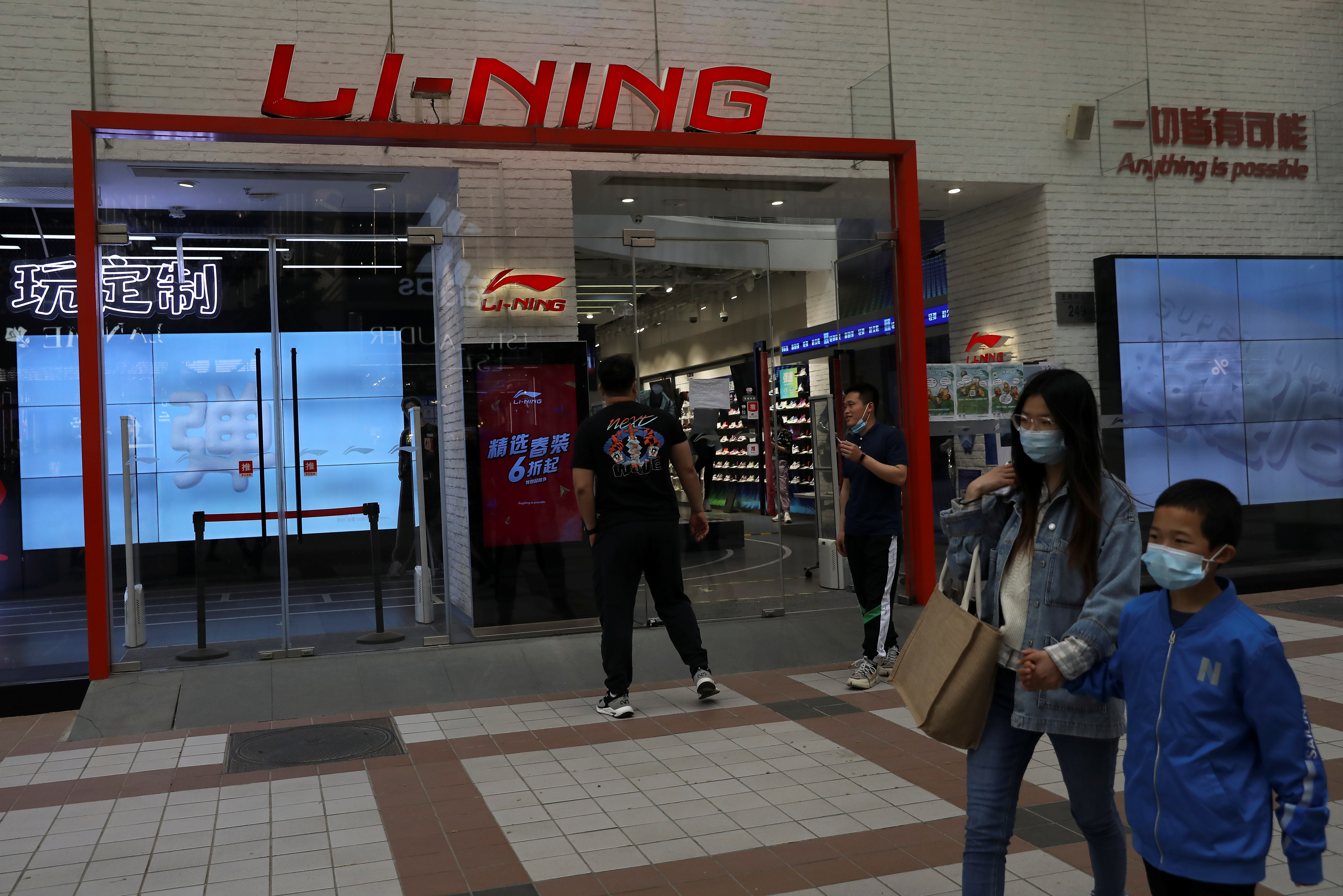 People walk past a store of Chinese sports products brand Li Ning in Beijing, China April 15, 2021. Picture taken April 15, 2021. REUTERS/Tingshu Wang