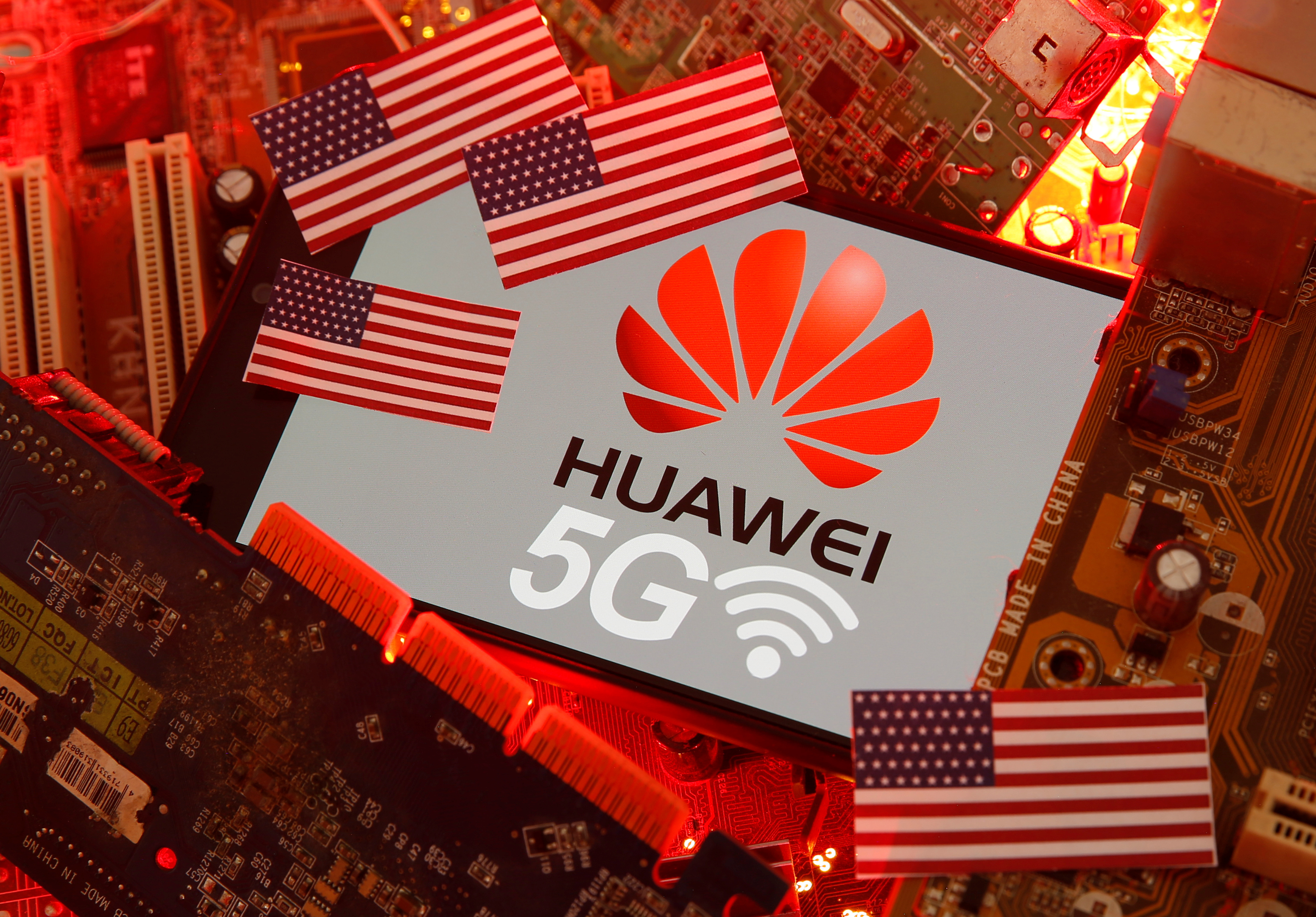 The U.S. flag and a smartphone with the Huawei and 5G network logo are seen on a PC motherboard in this illustratio