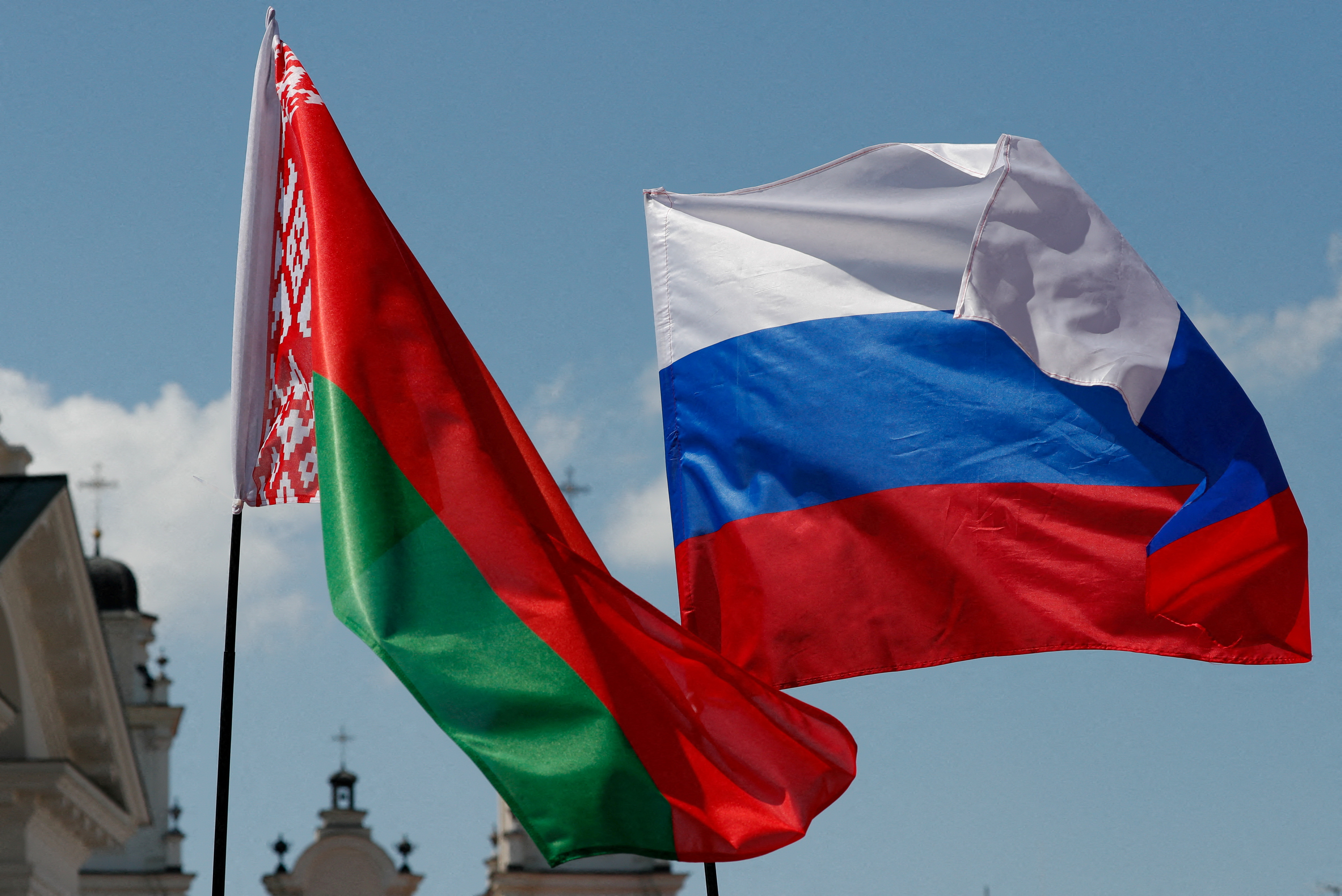 Belarusian and Russian national flags fly during 