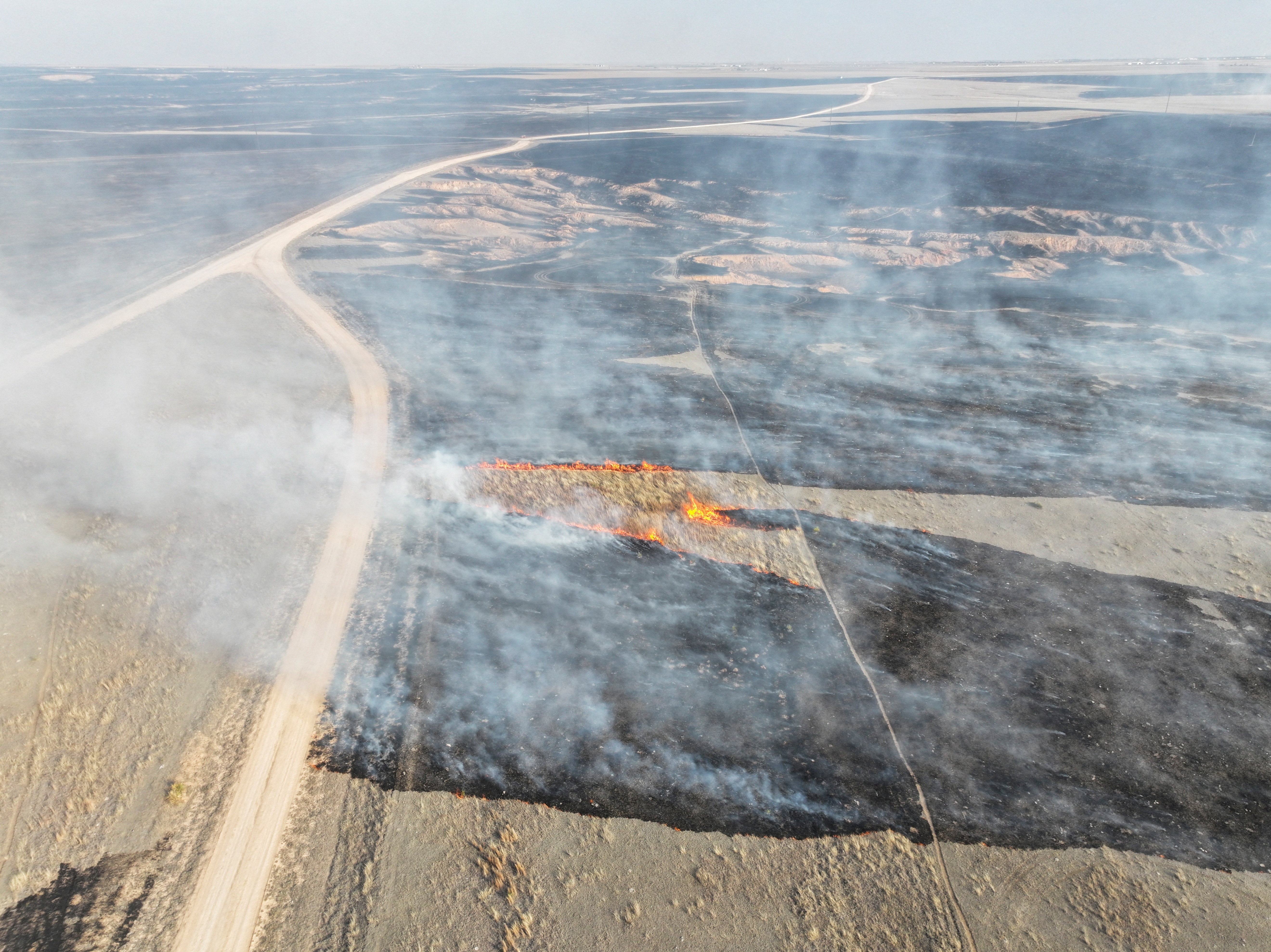 A drone view of the grasslands burning from the Smokehouse Creek Fire in Roberts County