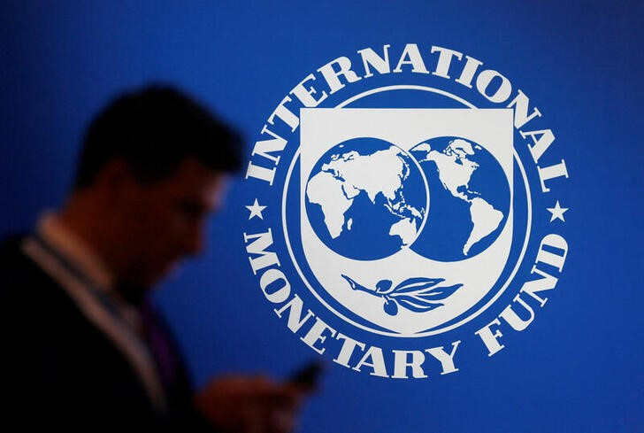 Ένας συμμετέχων στέκεται κοντά σε ένα λογότυπο του ΔΝΤ στο Διεθνές Νομισματικό Ταμείο - Ετήσια Συνάντηση Παγκόσμιας Τράπεζας 2018 στη Nusa Dua