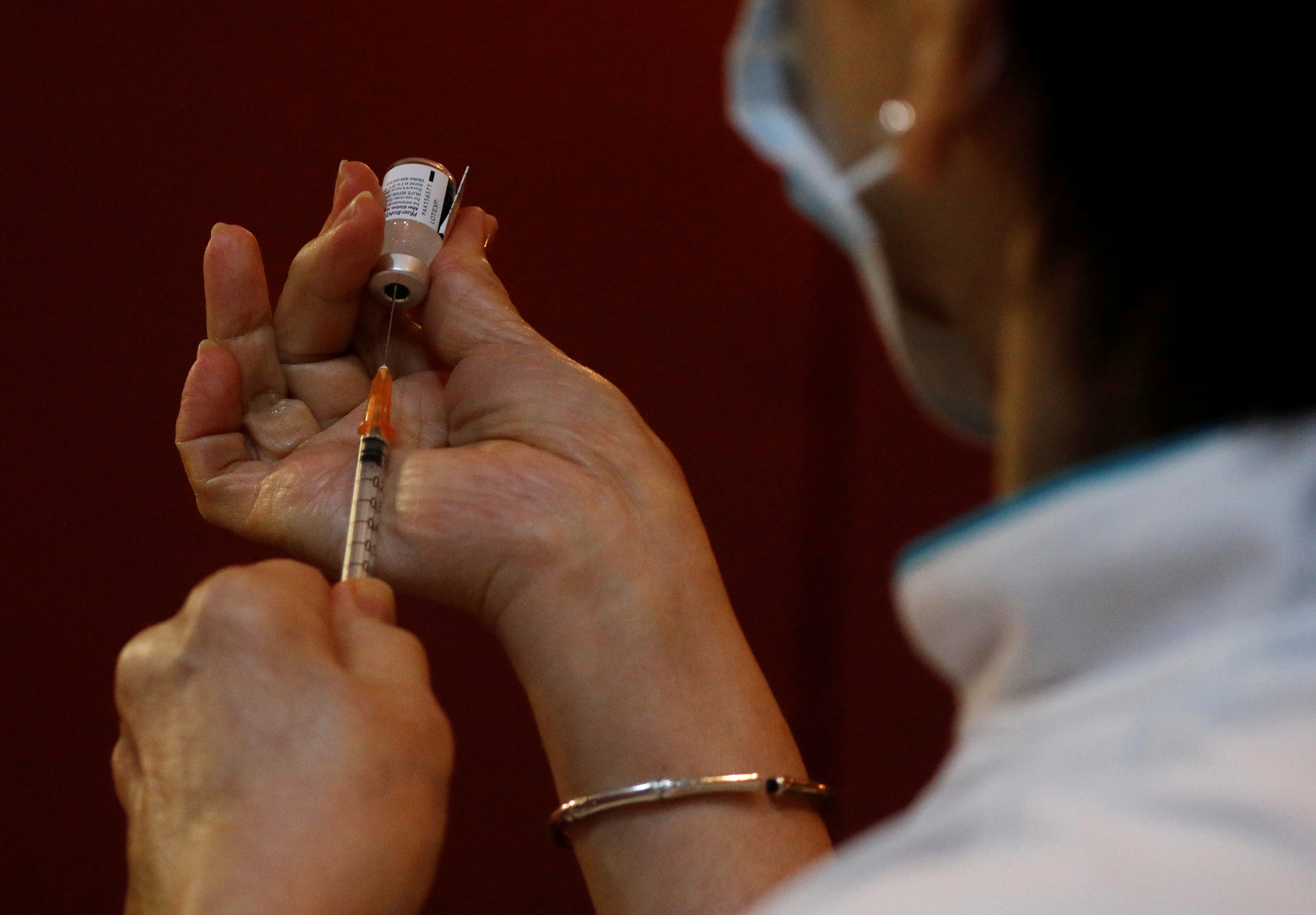 A nurse prepares to vaccinate healthcare workers in Singapore