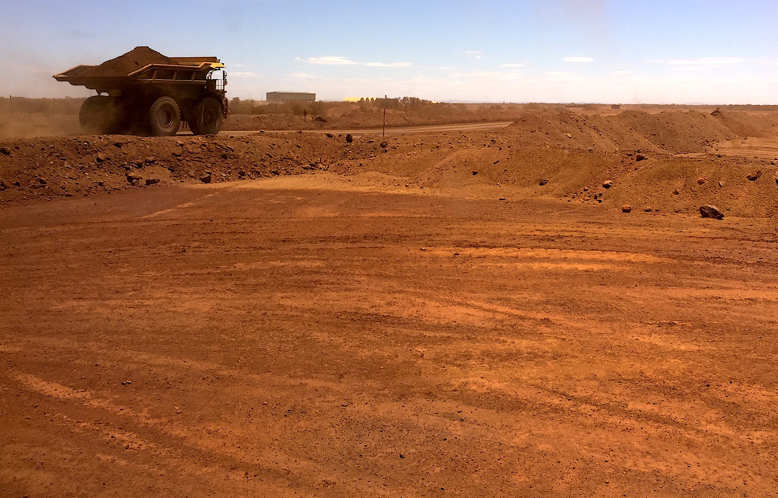 An autonomous vehicle drives along a road as it collects iron ore at Australia's Fortescue Metals Group (FMG) mine in the Pilbara region, located south-east of the coastal town of Port Hedland in Western Australia