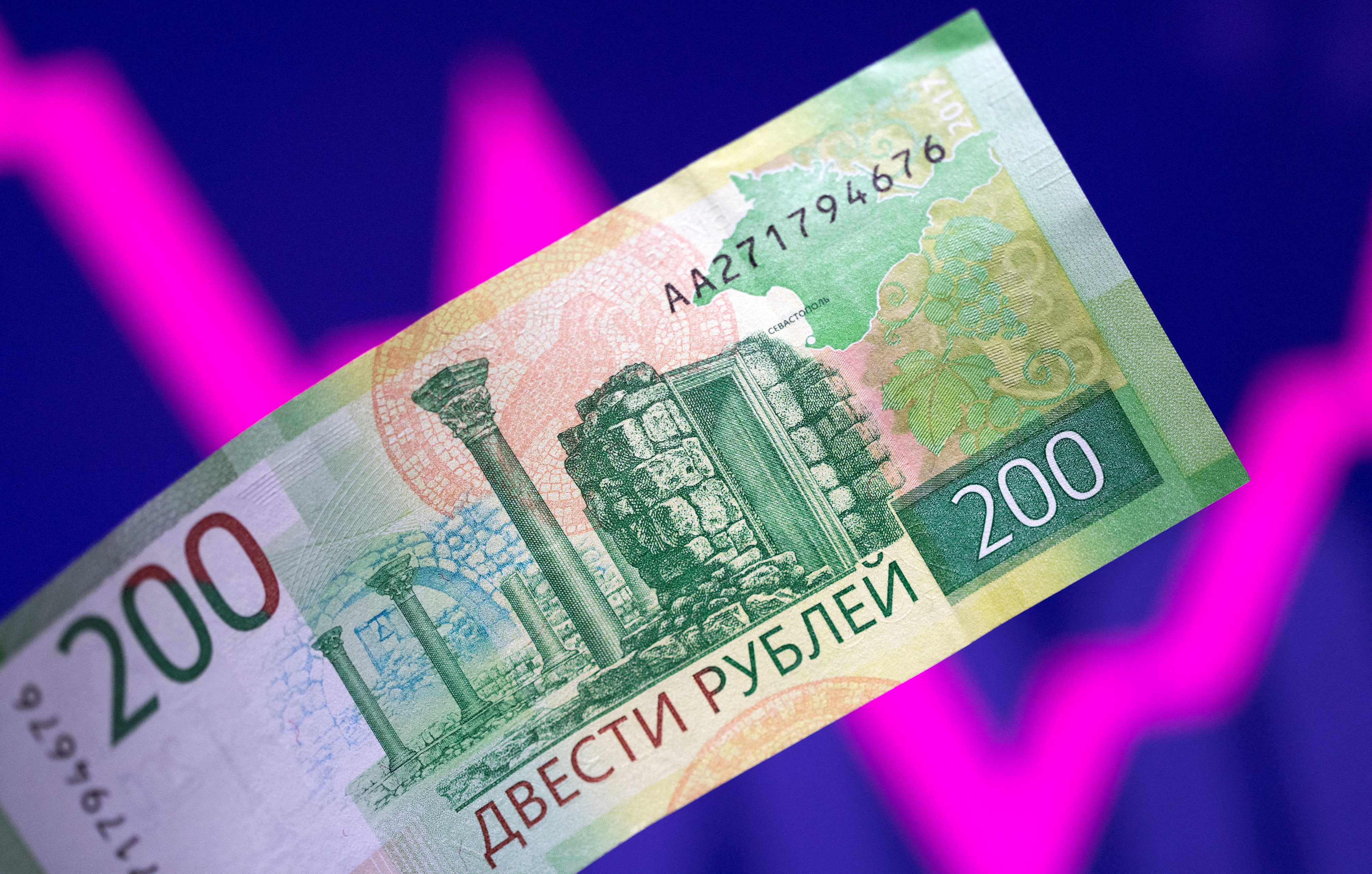 Illustration shows a Russian rouble banknote and a descending and rising stock graph