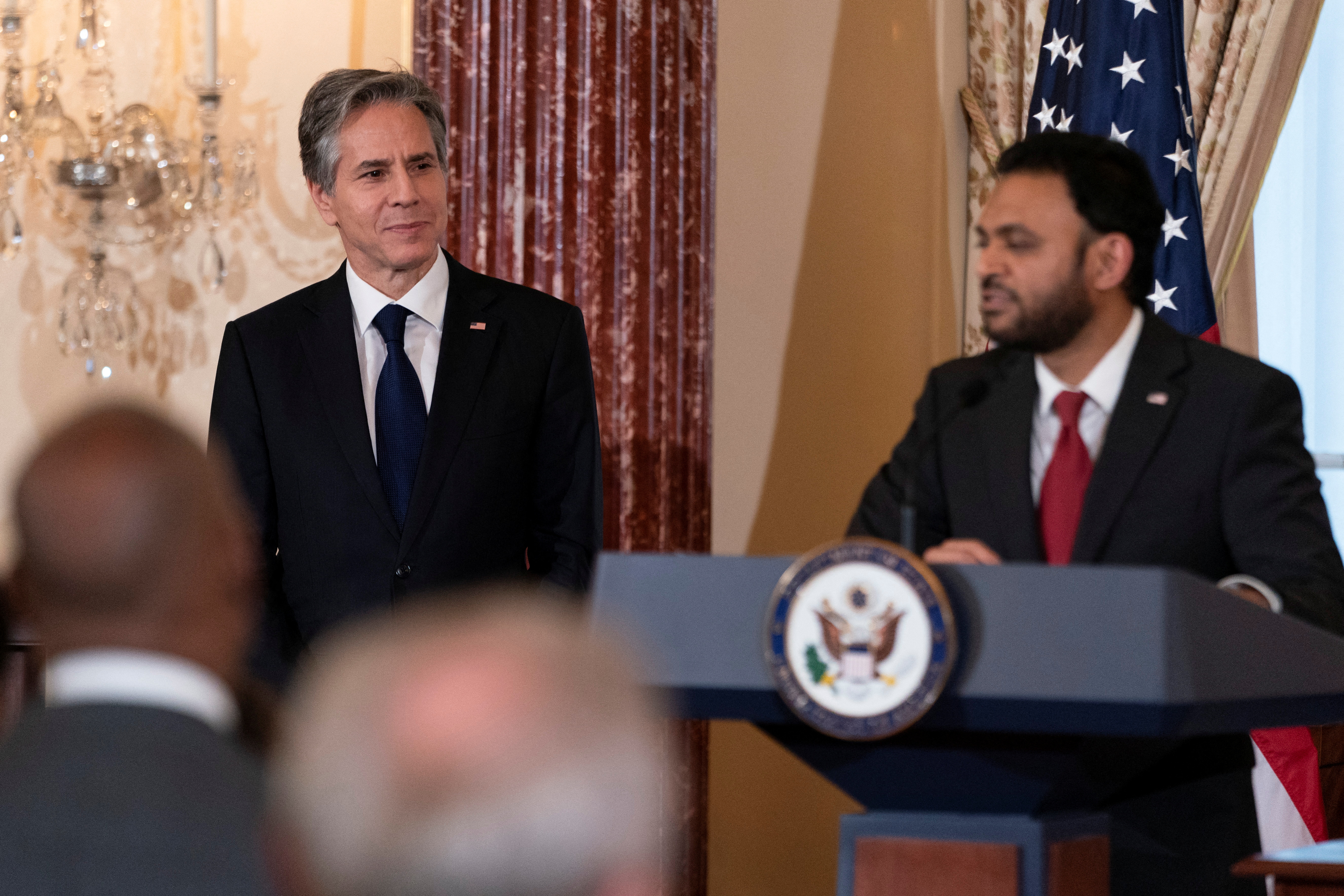 U.S. Secretary of State Antony Blinken listens as Ambassador at Large for Religious Freedom Rashad Hussain speaks during a reception celebrating Eid in Washington