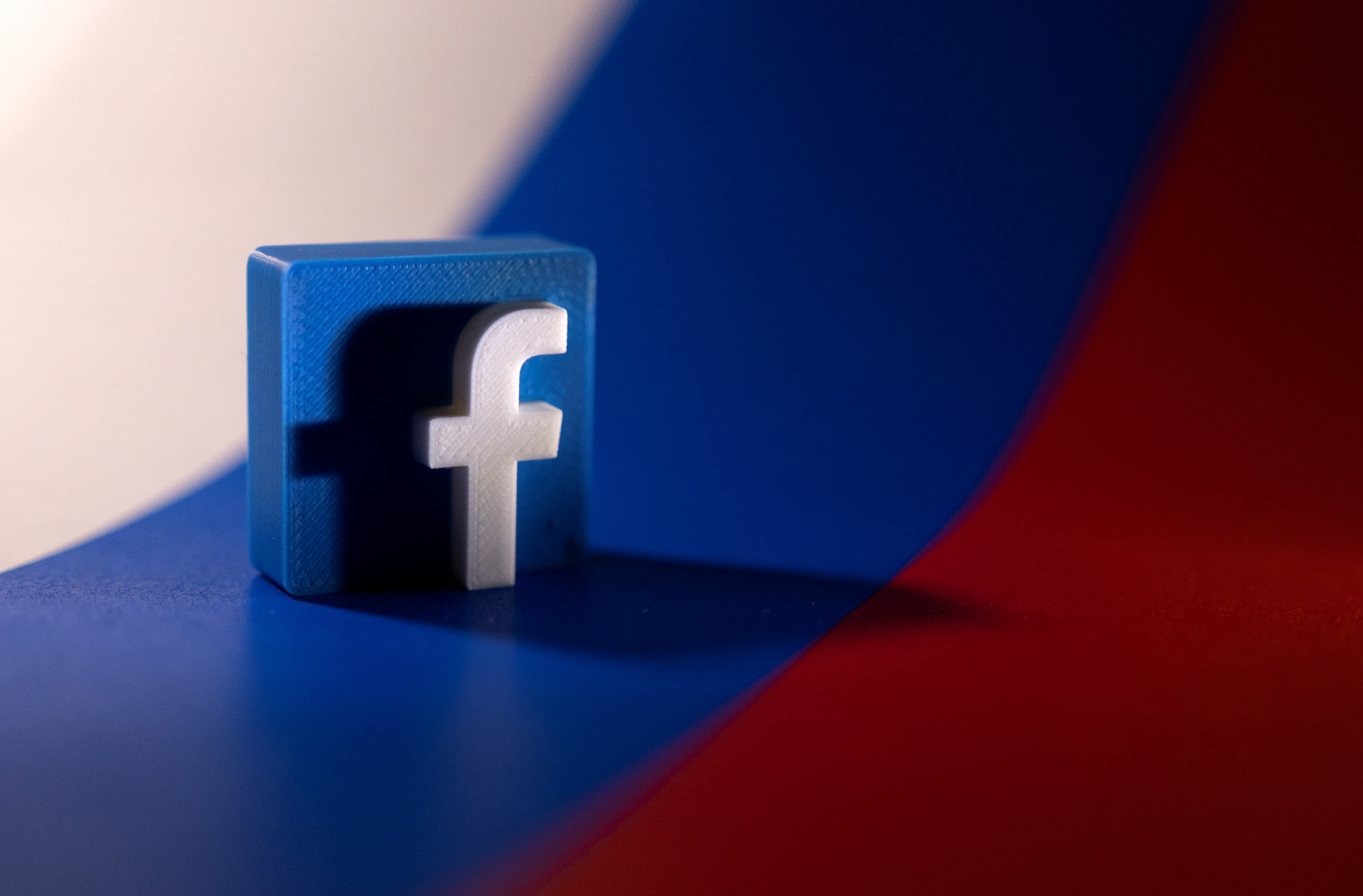 Illustration shows Facebook logo and Russian flag