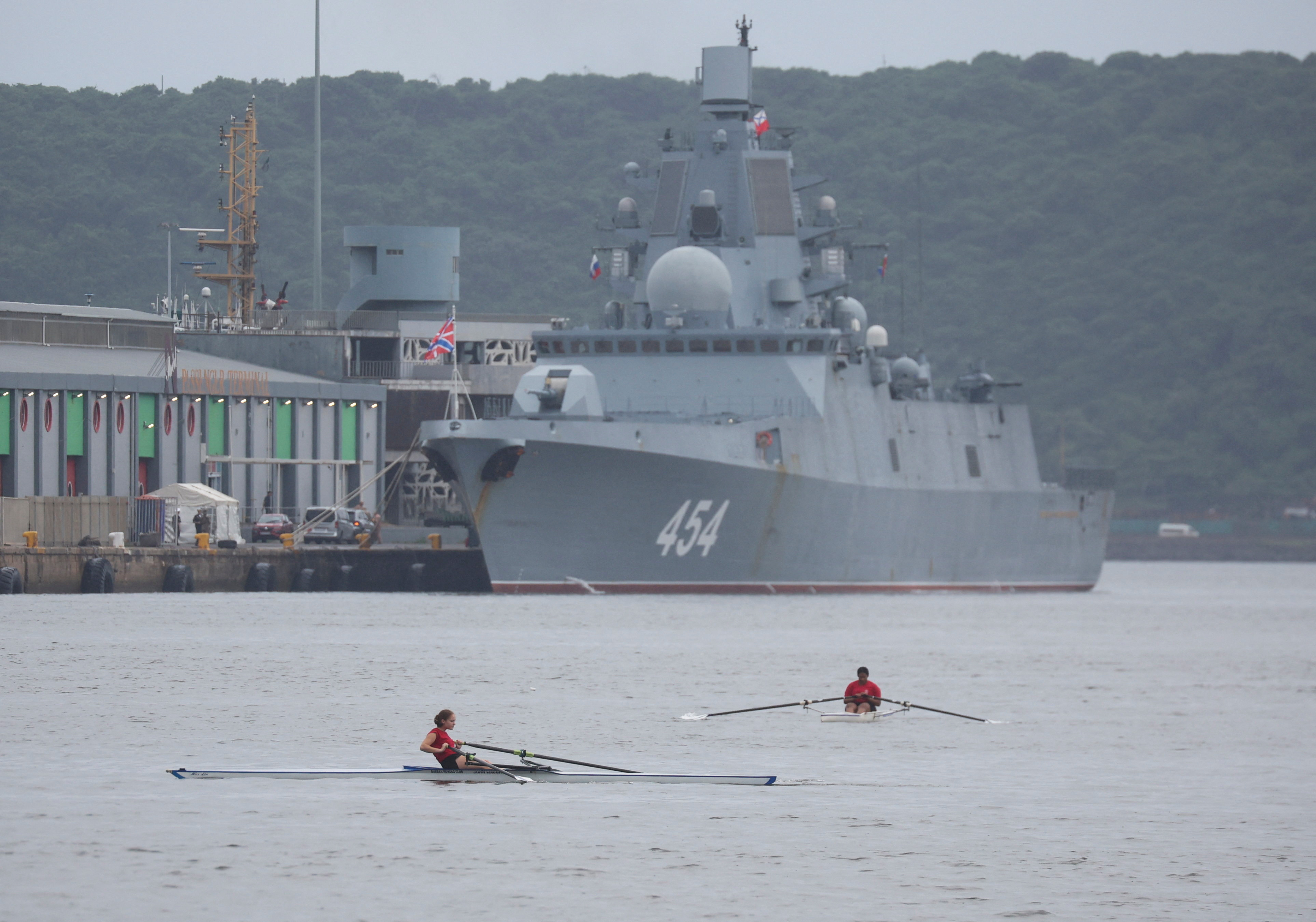 Rowers pass the Russian frigate Admiral Gorshkov which is docked en route to scheduled naval exercises with the South African and Chinese navies in Durban