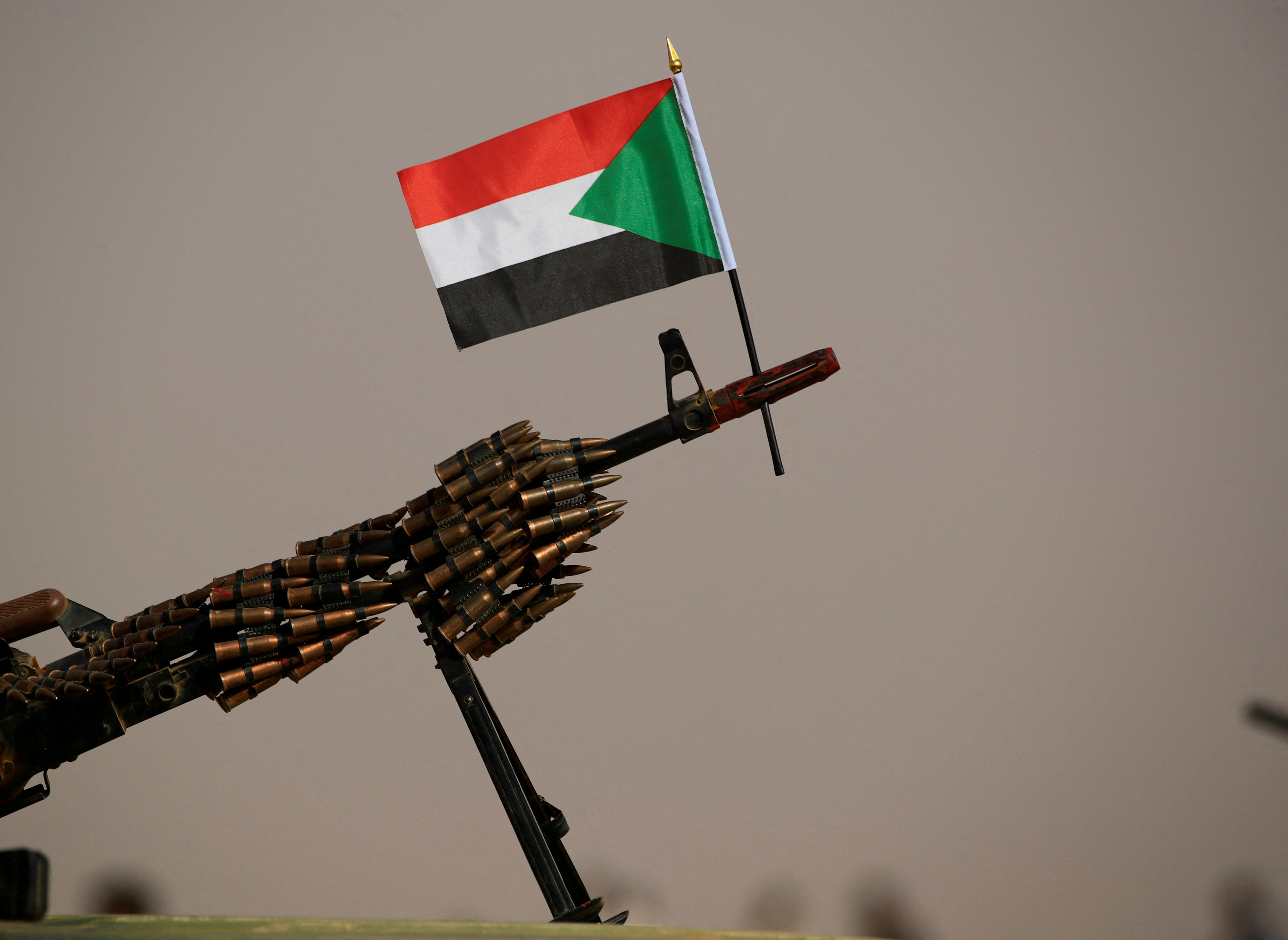 A Sudanese national flag is attached to a machine gun of Paramilitary Rapid Support Forces (RSF) soldiers as they wait for the arrival of Lieutenant General Mohamed Hamdan Dagalo before a meeting