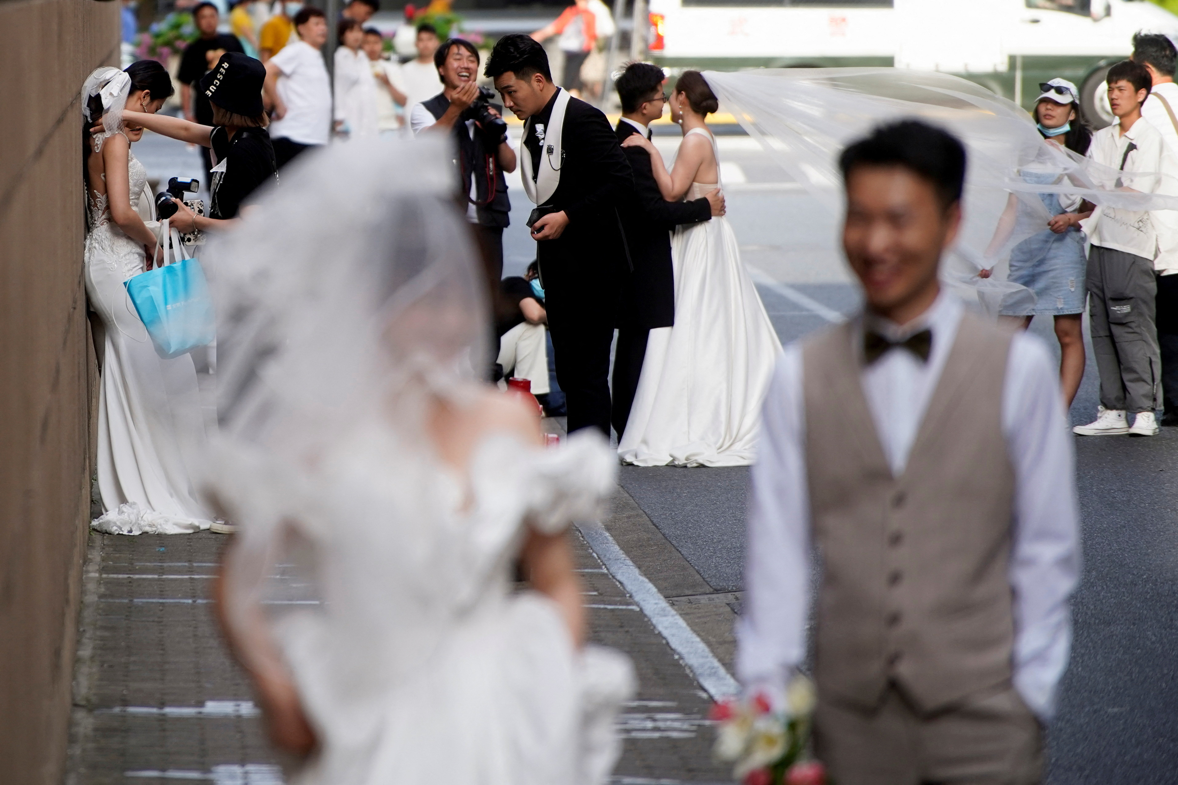 Couples prepare to get their photo taken during a wedding photography shoot, amid the coronavirus disease pandemic, in Shanghai