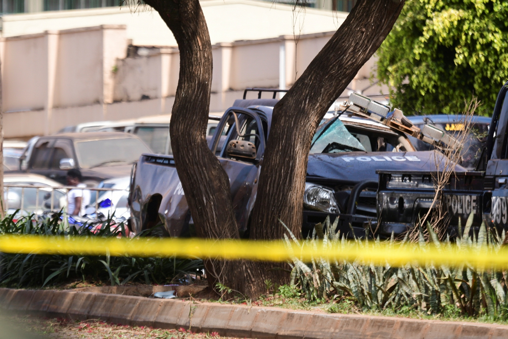 A general view shows wreckages of police vehicles at the scene of a blast in Kampala