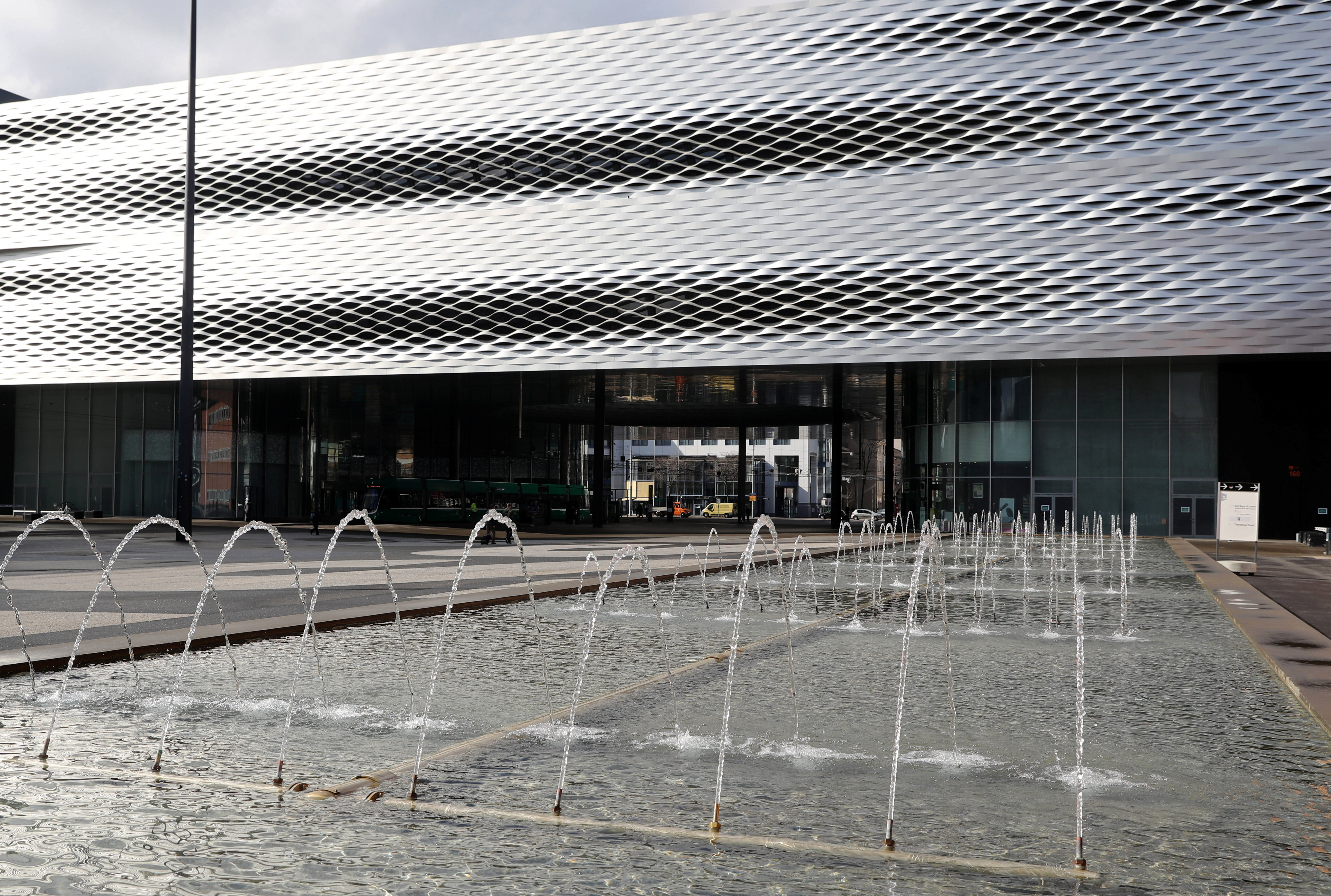 Water gushes from a fountain in front of the halls of Messe Basel fairground designed by Swiss architects Herzog & de Meuron in Basel
