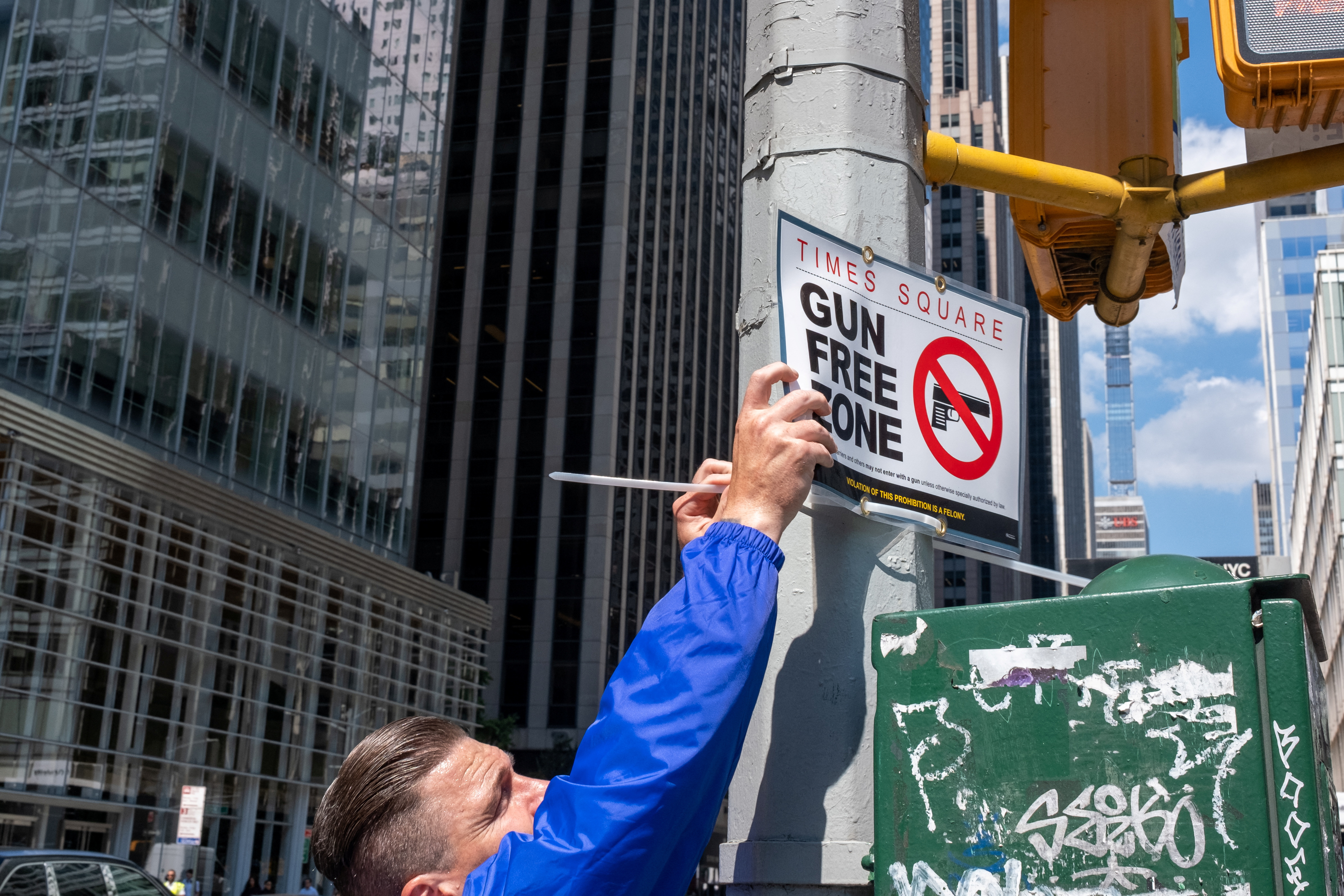 FILE PHOTO - New York City police officers instal signs that read 