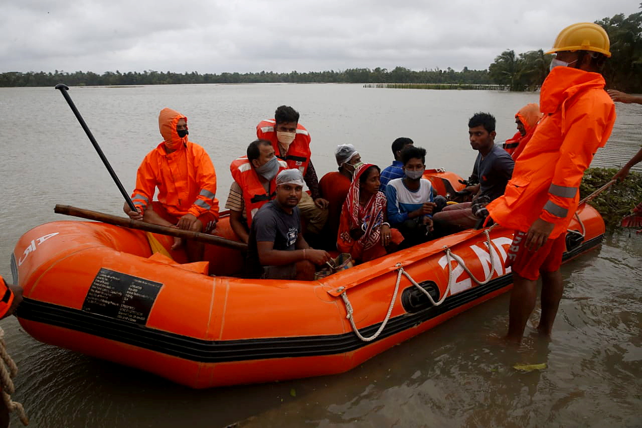 Members of NDRF evacuate people from flooded area to safer place as Cyclone Yaas makes landfall at Ramnagar
