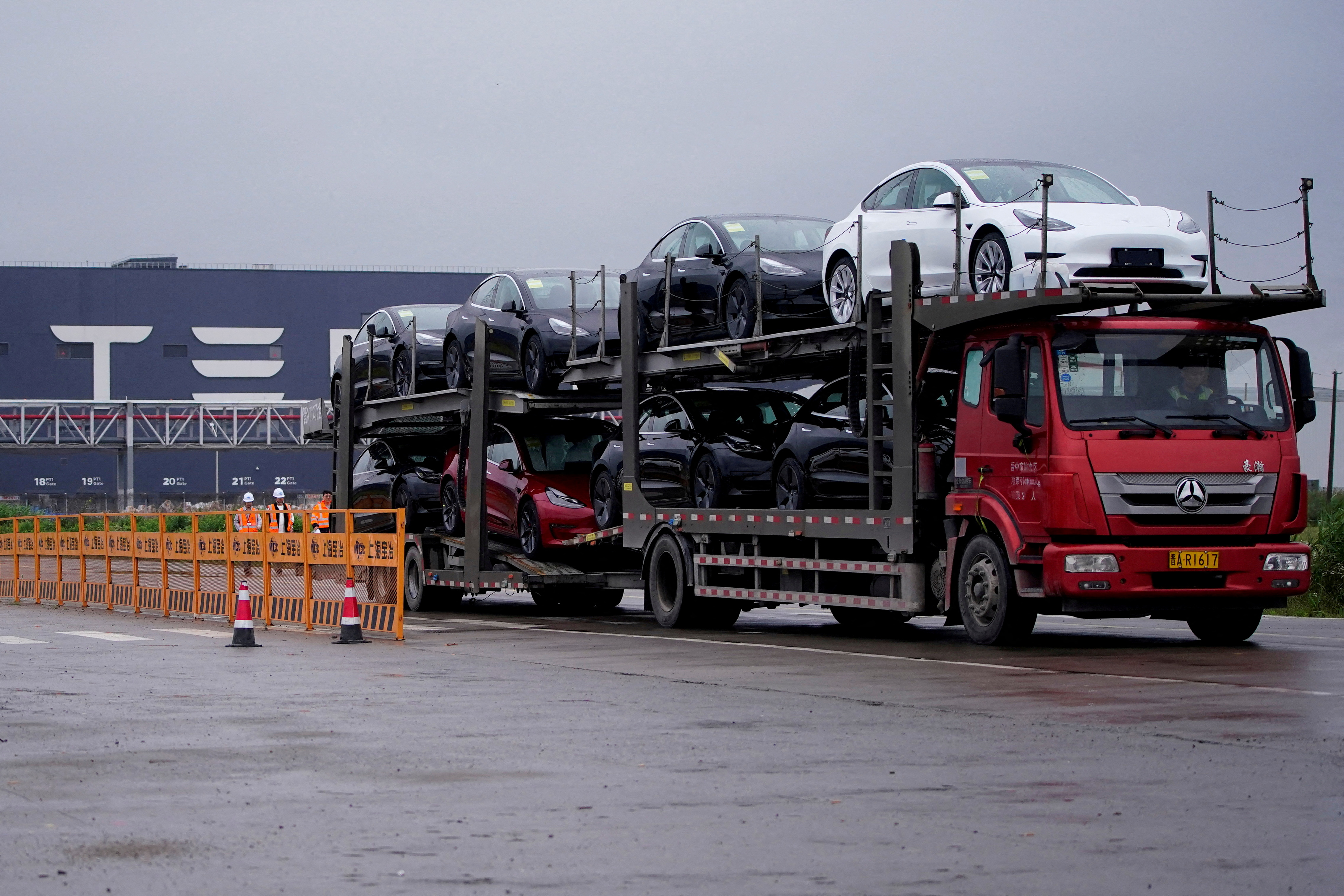 A truck transports new Tesla cars at its factory in Shanghai